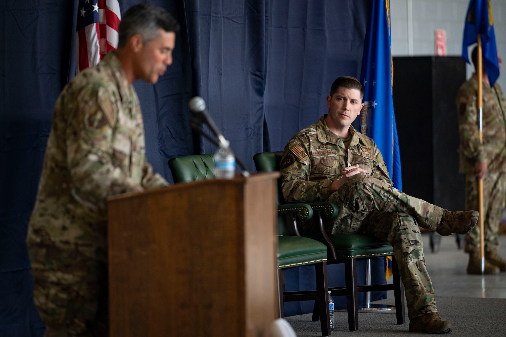 Pictured above is a man speaking into a microphone.