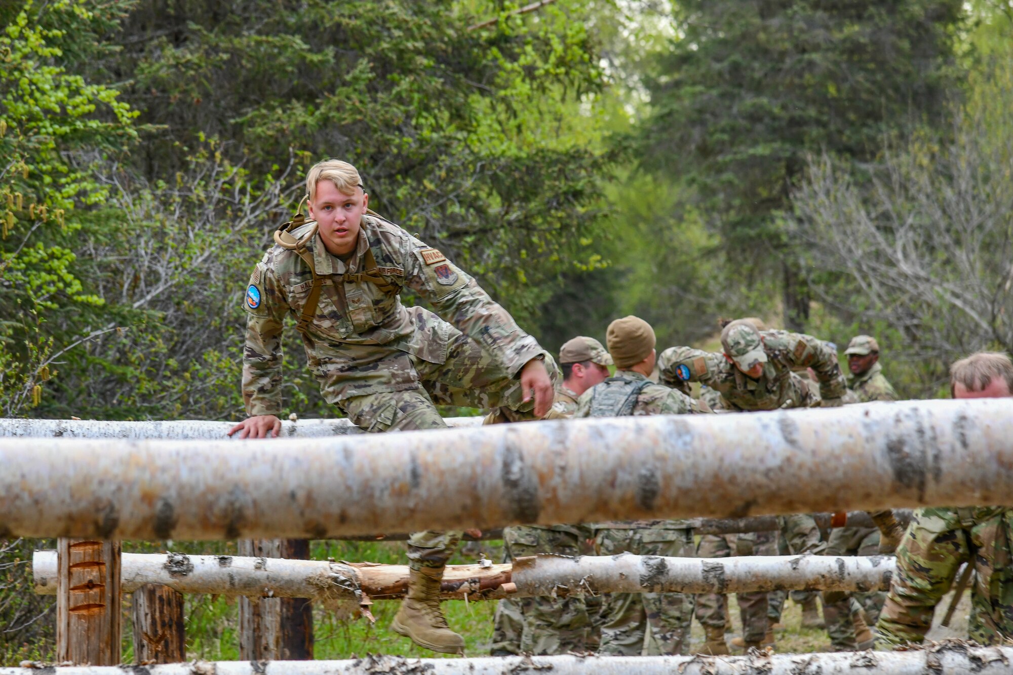 A photo of Airmen of the 177th, 108th, and 111th Civil Engineer Squadrons completing an obstacle course.