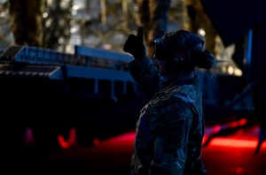 U.S. Air Force Senior Airman Courtney Decker assigned to the 721st Aerial Port Squadron, assists with guiding an aircraft cargo loader during Exercise Defender Europe 23 at Larissa Air Base, Greece, May 13, 2023.