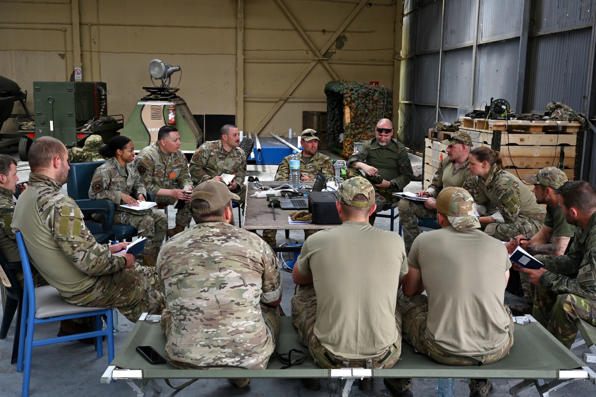 U.S. Air Force Airmen, assigned to the 521st Air Mobility Operations Wing, and Dutch soldiers, assigned to the 11th Air Assault Brigade, discuss airlift plans during Exercise Defender Europe 23 at Larissa Air Base, Greece, May 15, 2023.