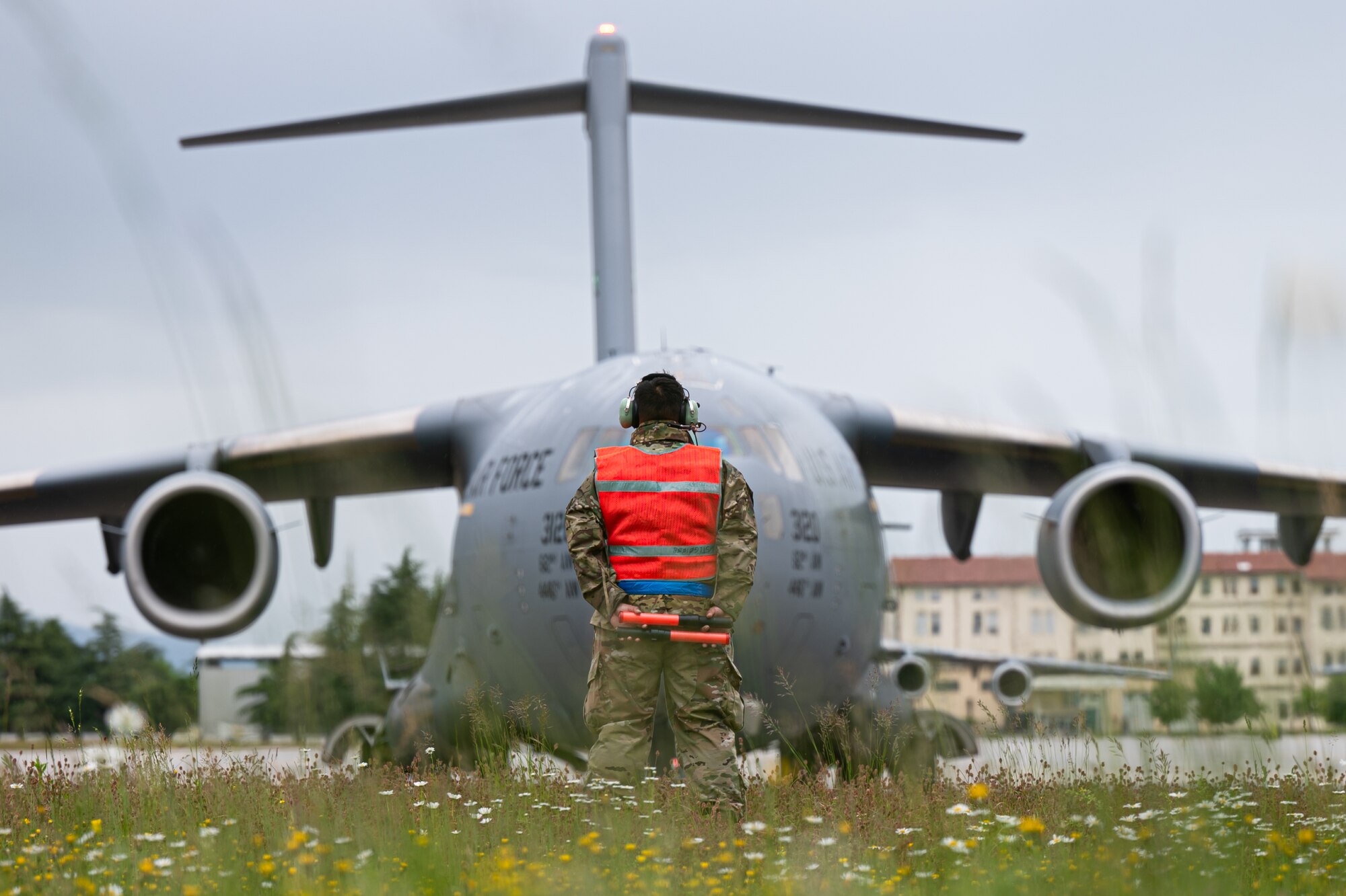 Staff Sgt. Billy Jean Meyer, an avionics specialist from the 725th Air Mobility Squadron, Naval Station Rota, Spain, marshals a C-17 Globemaster III prior to takeoff from Aviano Air Base, Italy, on May 16, 2023.