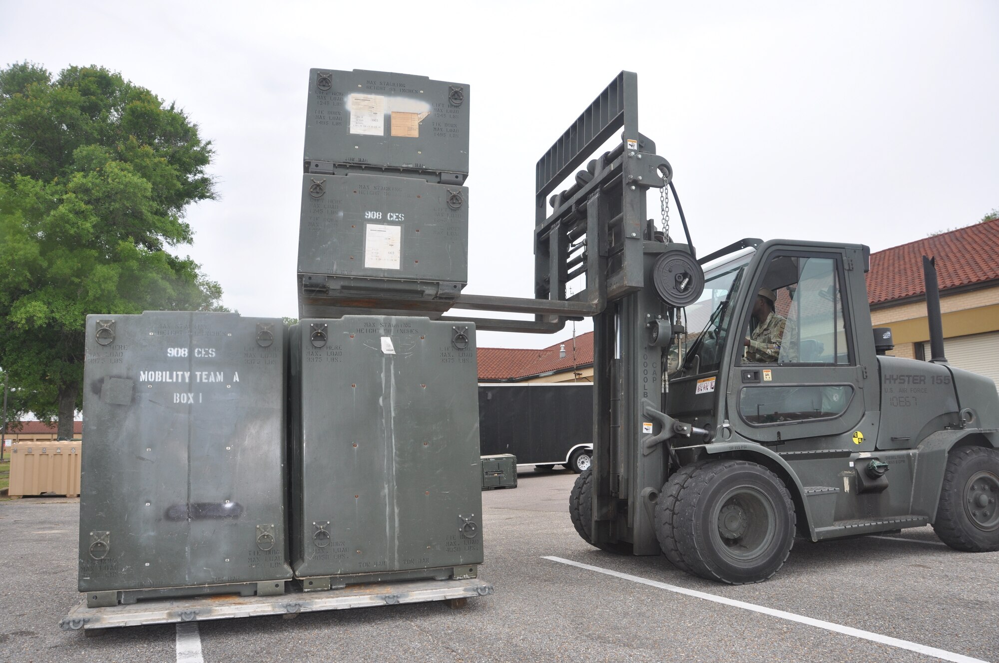 two people move equipment with a forklift