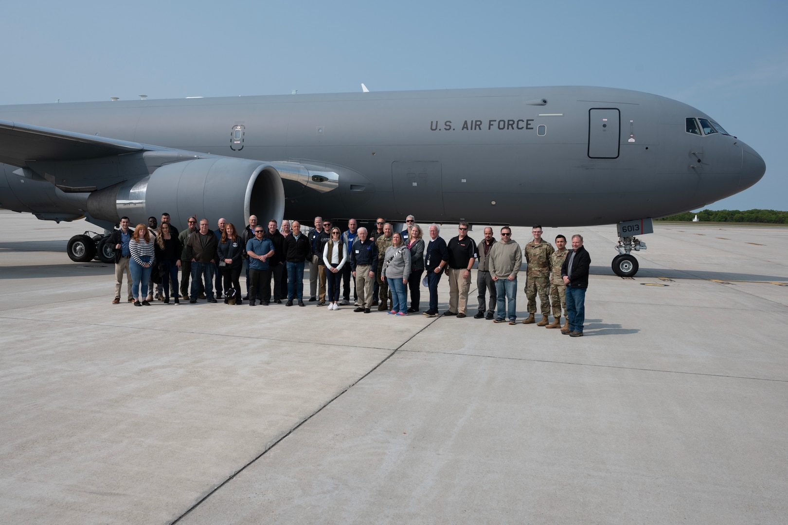 Group stands in front of a KC-46