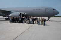 Group stands in front of a KC-46