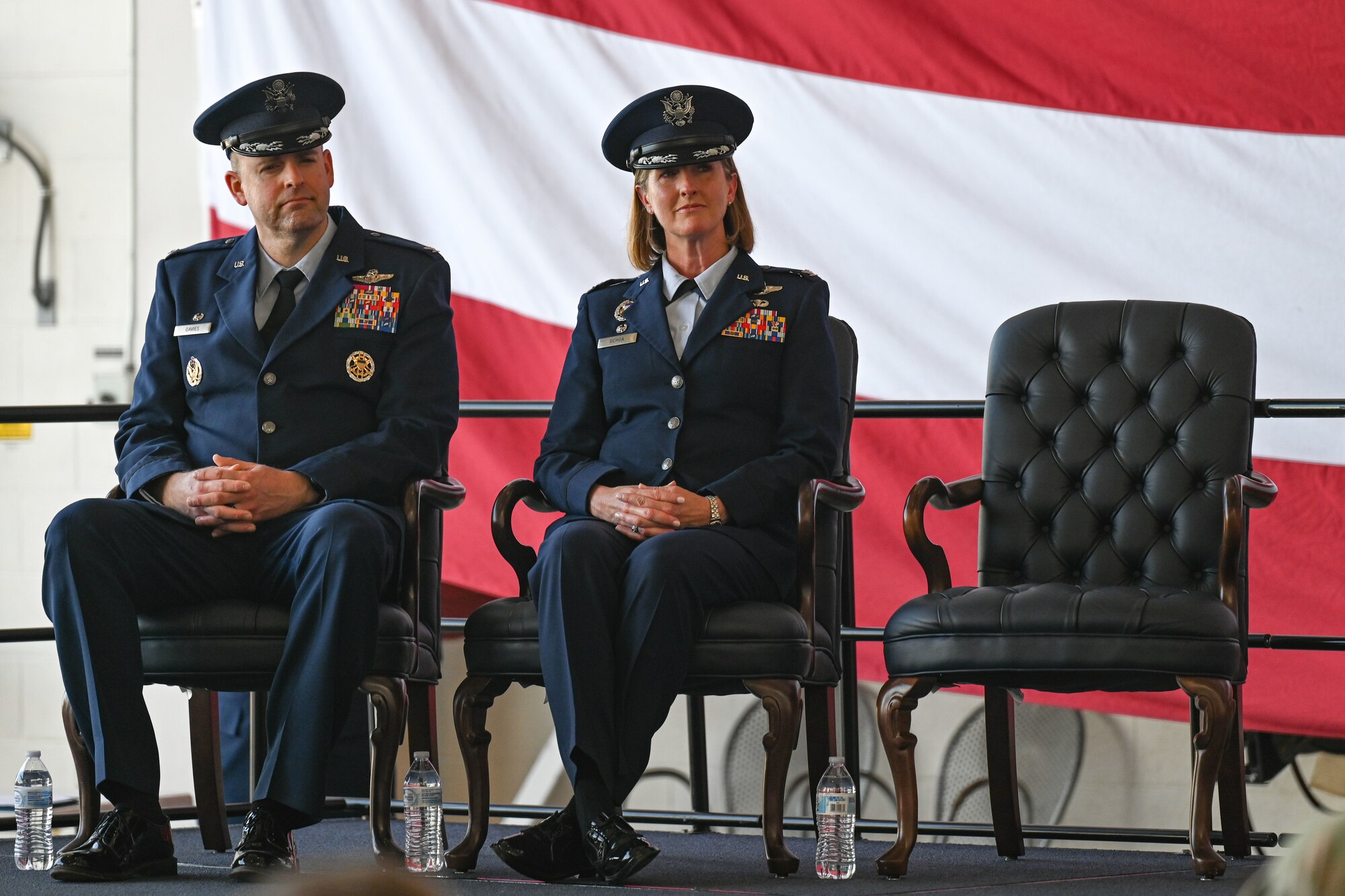 Airmen from the 19th Airlift Wing participate in a change of command ceremony in an airplane hangar