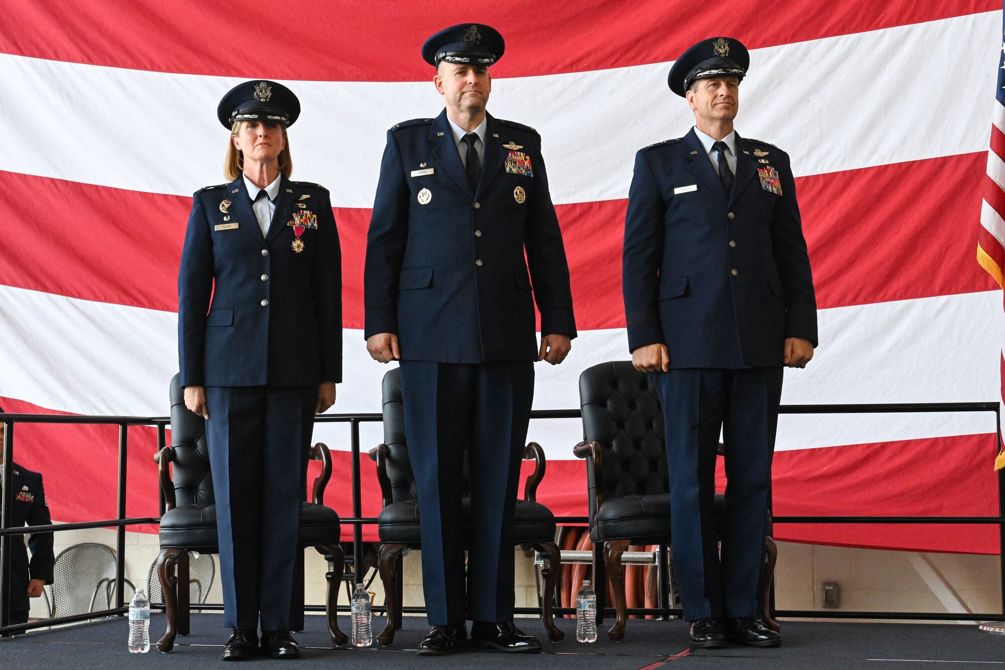 Airmen from the 19th Airlift Wing participate in a change of command ceremony in an airplane hangar