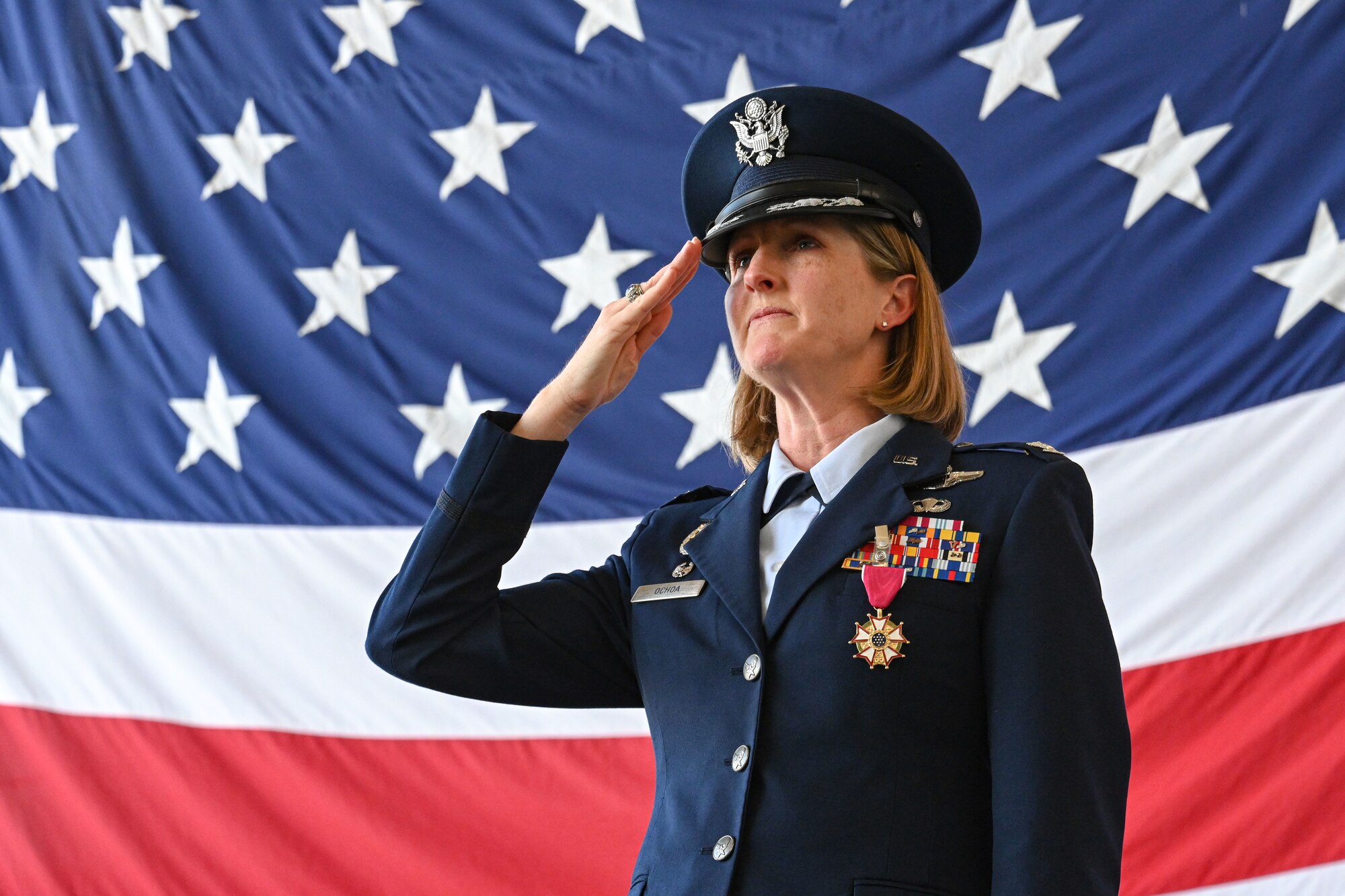 Airmen from the 19th Airlift Wing participate in a change of command ceremony in an airplane hangar