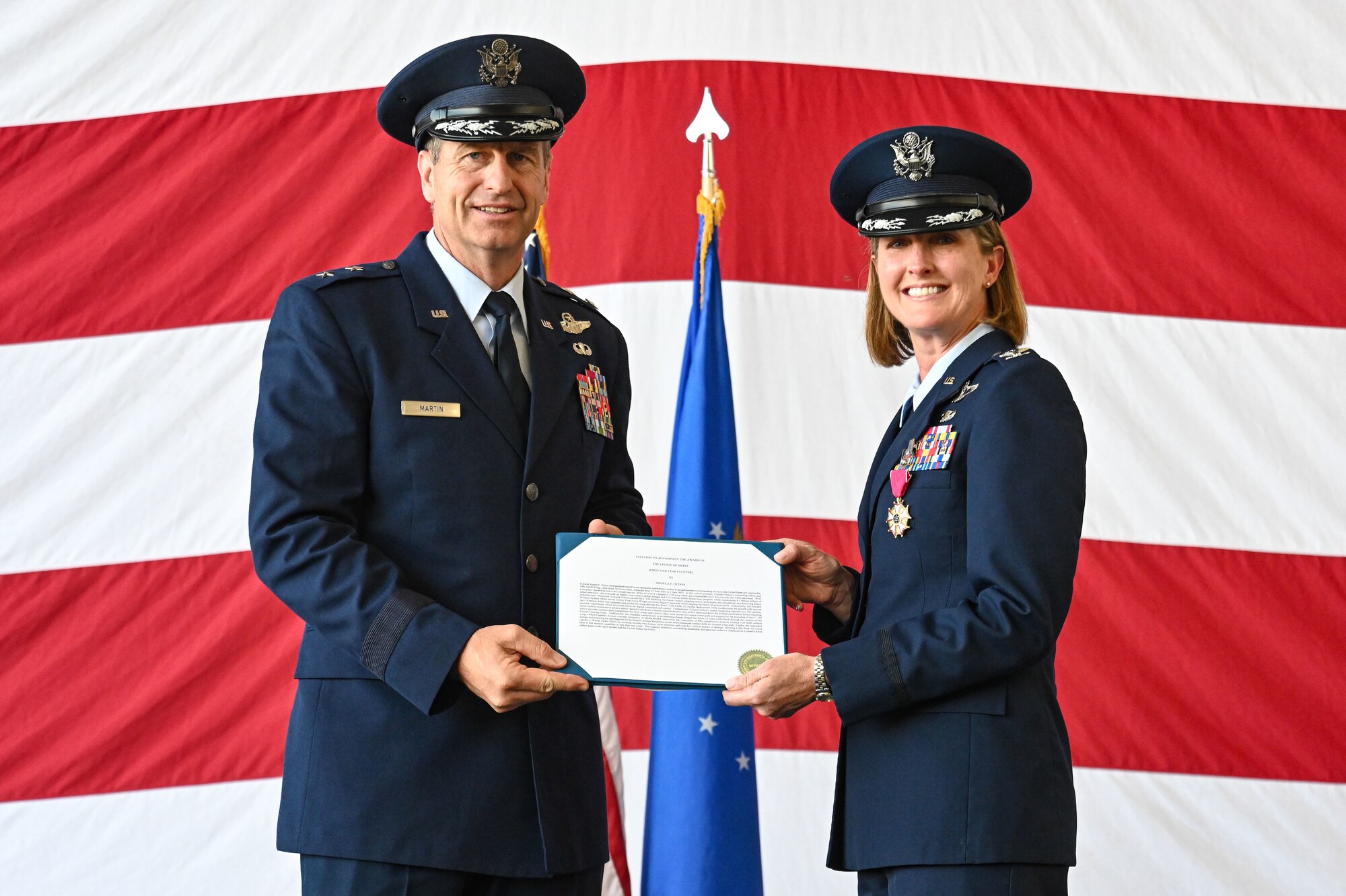 Airmen from the 19th Airlift Wing participate in a change of command ceremony in an airplane hangar