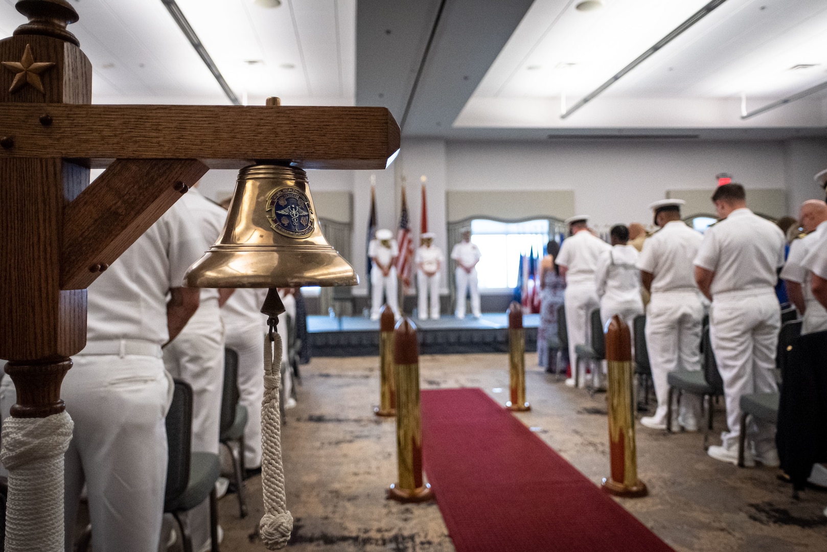 Attendees and participants of the Naval Health Clinic Cherry Point change of command ceremony bow their heads during the ceremony’s invocation Wednesday, May 31, 2023 aboard Marine Corps Air Station Cherry Point.  Capt. Sean Barbabella assumed command of the clinic from Capt. Elizabeth Adriano during the ceremony.