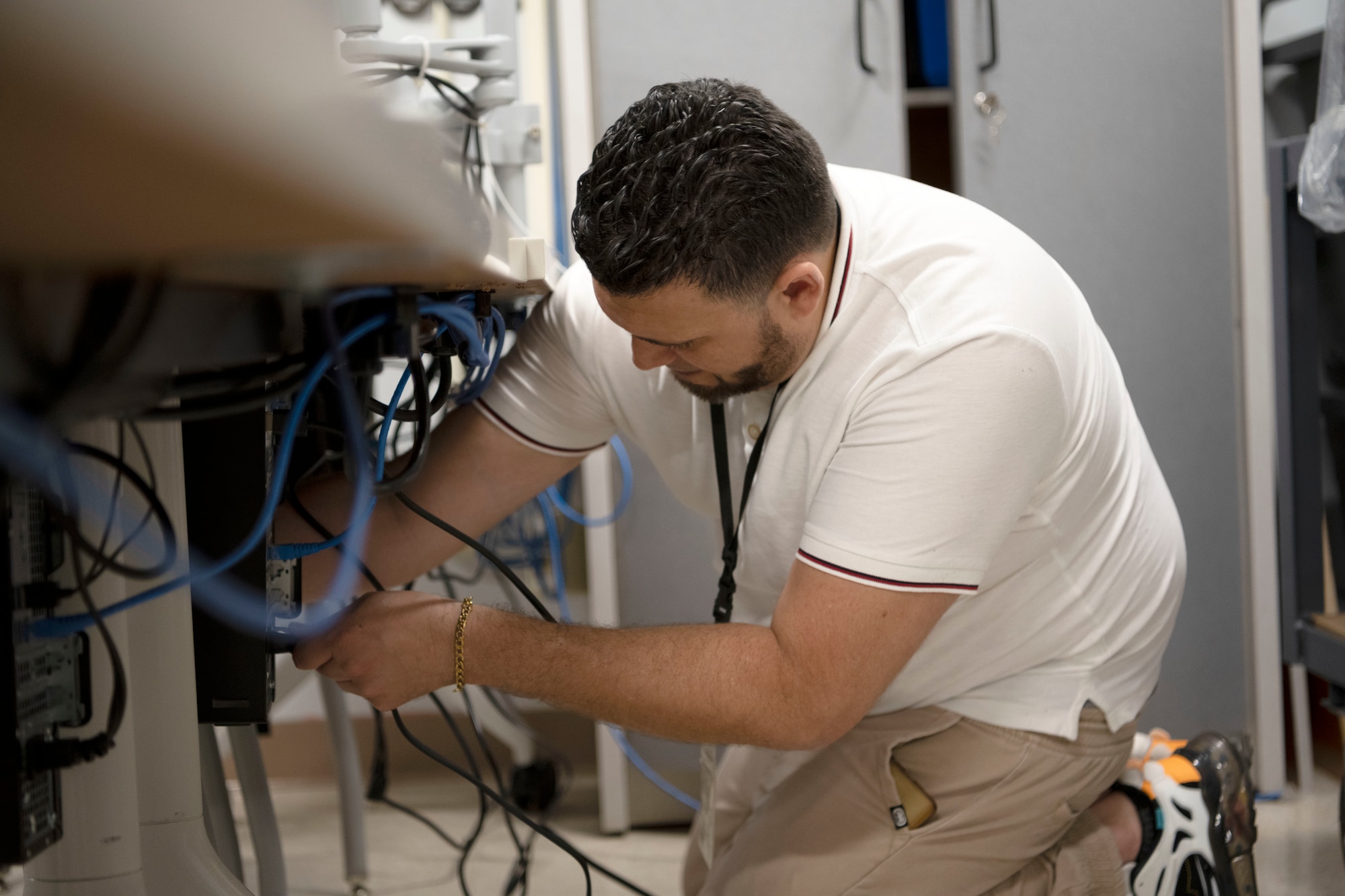 Freddie Ayala Guzman, a civilian contractor, installs network wires for new computers at the STARBASE Puerto Rico computer laboratory at Muñiz Air National Guard Base, Carolina, Puerto Rico, May 22, 2023. The STARBASE PR program modernized its computer laboratory with 33 brand-new PCs and upgraded their internet service providing staff and students with reliable and updated software and connectivity. (U.S. Air National Guard photo by Master Sgt. Rafael D. Rosa)