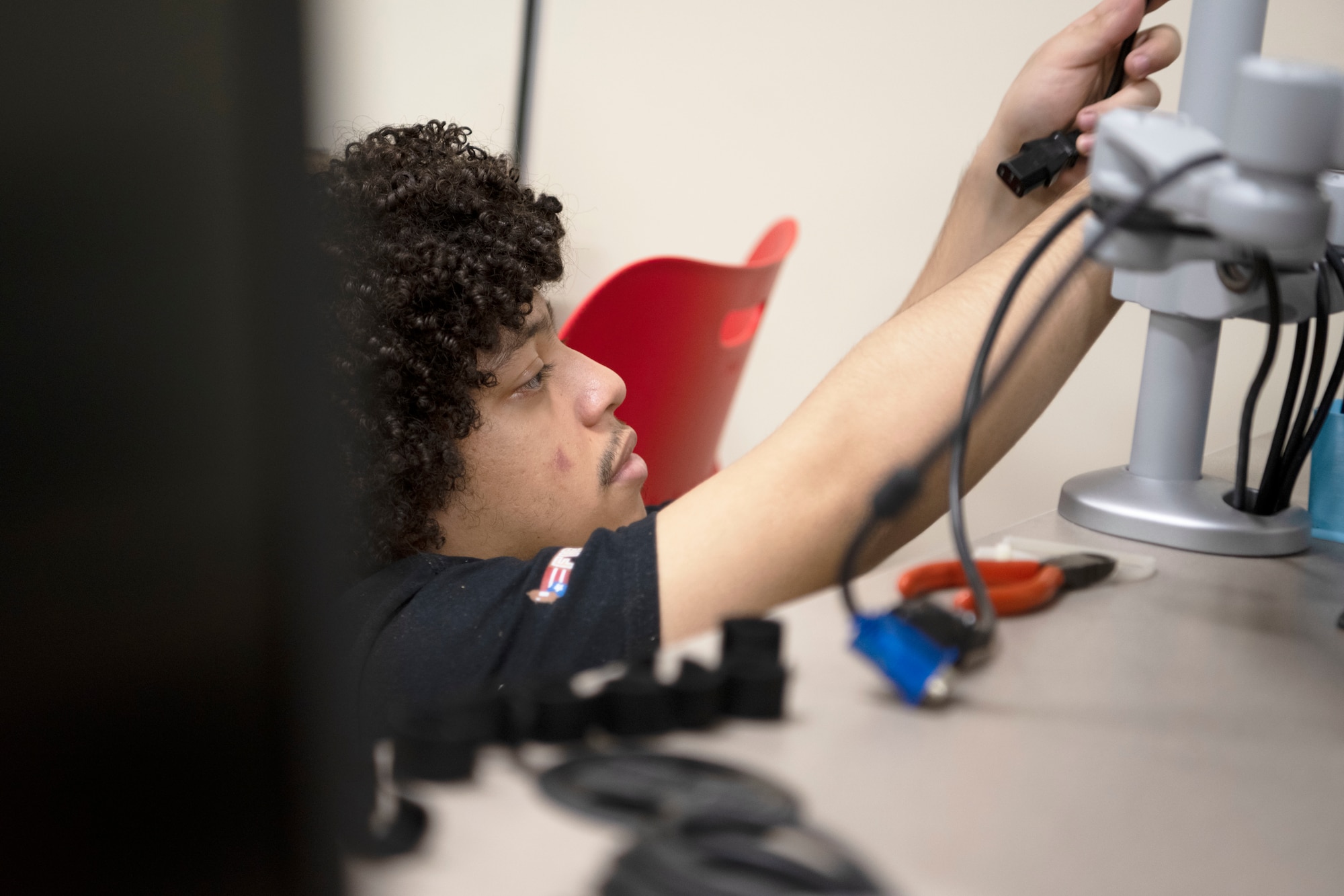 Ian Zayas Ayala, a civilian contractor, connects new computers at the STARBASE Puerto Rico computer laboratory at Muñiz Air National Guard Base, Carolina, Puerto Rico, May 22, 2023. The STARBASE PR program modernized its computer laboratory with 33 brand-new PCs and upgraded their internet service providing staff and students with reliable and updated software and connectivity. (U.S. Air National Guard photo by Master Sgt. Rafael D. Rosa)