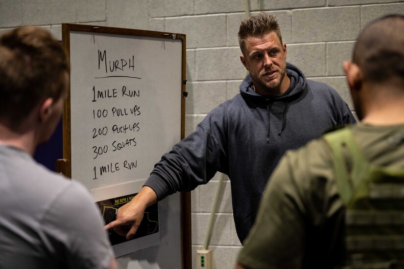 Airmen study a work out as part of the Murph Challenge.