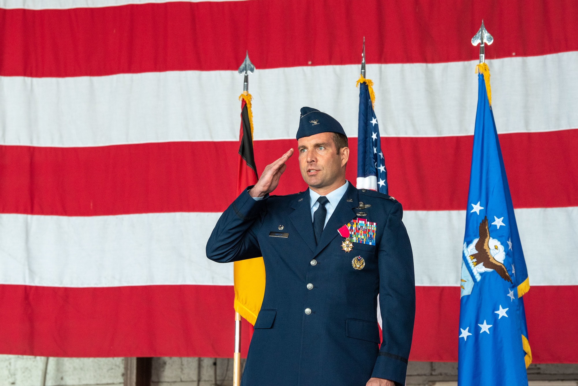 U.S. Air Force Col. Leslie Hauck, 52nd Fighter Wing outgoing commander, renders a final salute to members of the 52nd FW during a change of command ceremony