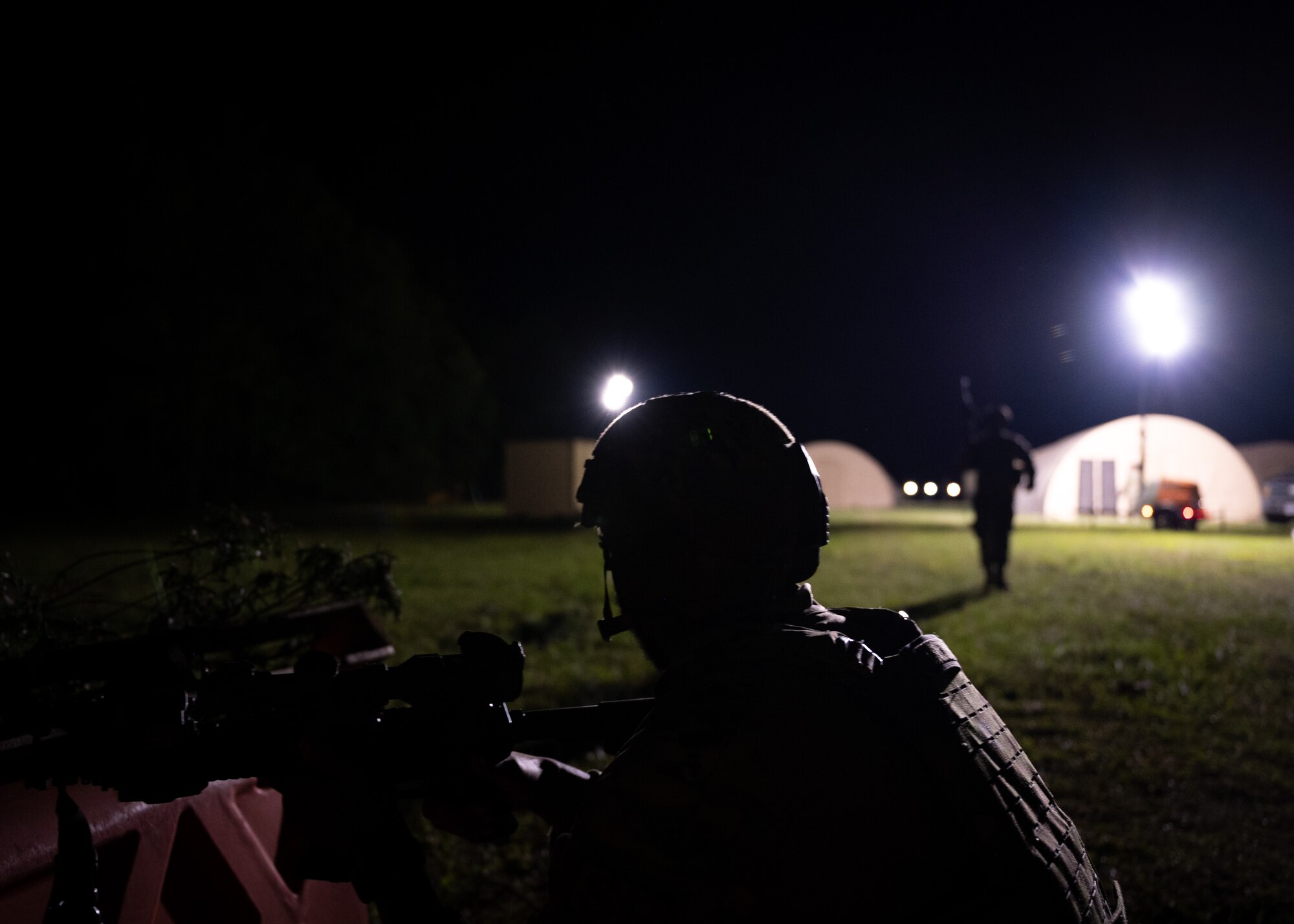 An Airman holds a weapon in a defensive position during a training exercise.