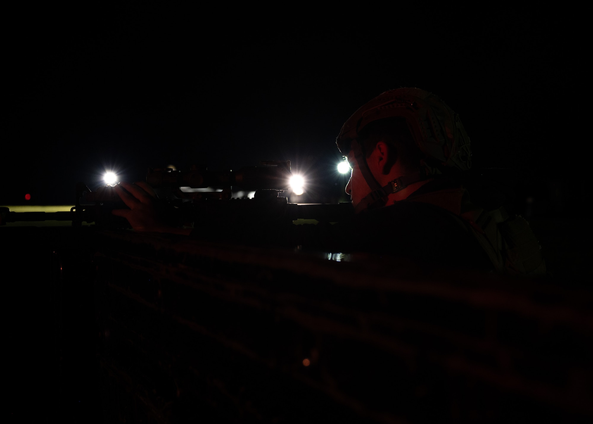 An Airman holds a weapon in a defensive position during a training exercise.
