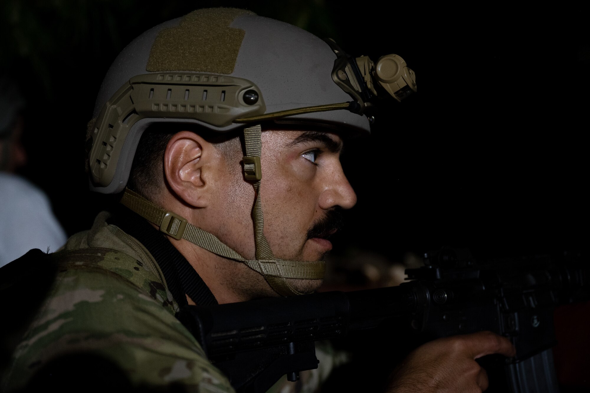 An Airman holds a weapon in a defensive position during a training exercise.