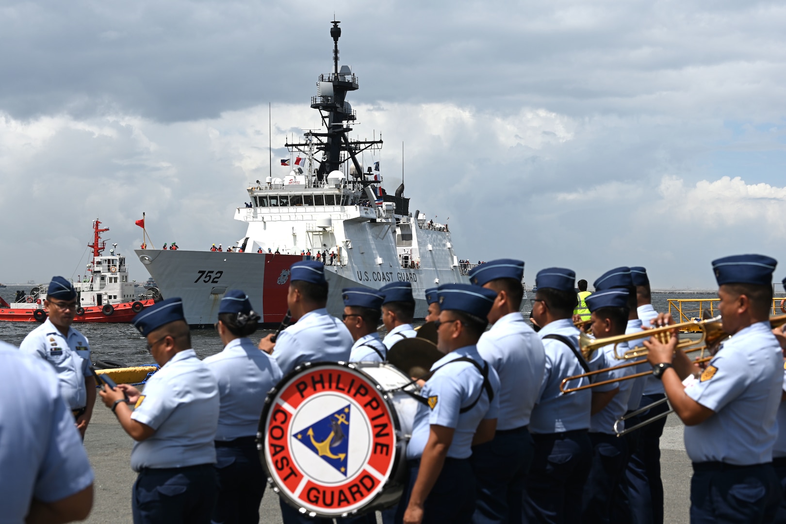 Philippine Coast Guard servicemembers play music as the U.S. Coast Guard Cutter Stratton (WMSL 752) arrives in Manila, Philippines, for a tri-lateral engagement with the Philippine and Japan Coast Guards, June 1, 2023. Stratton deployed to the Western Pacific under U.S. Navy 7th Fleet command to serve as a non-escalatory asset for the promotion of a rules-based order in the maritime domain by engaging with partner nations and allies in the region. (U.S. Coast Guard photo by Chief Petty Officer Matt Masaschi)