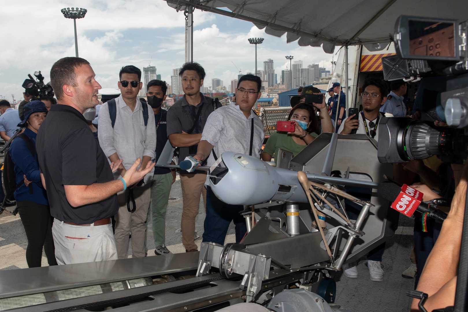 Unmanned Aerial System Operator Troy Spence explains the ScanEagle UAS during a media tour on the flight deck of U.S. Coast Guard Cutter Stratton (WMSL 752) after the ship moored in the Port of Manila, Philippines, June 1. Stratton deployed to the Western Pacific under U.S. Navy 7th Fleet command as a non-escalatory asset for the promotion of a rules-based order in the maritime domain by engaging with partner nations and allies in the region. (U.S. Navy photo by Chief Petty Officer Brett Cote)