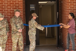 Members of the 6th Air Refueling Wing cut a ribbon during a dormitory reopening ceremony at MacDill Air Force Base, Florida, June 1, 2023.