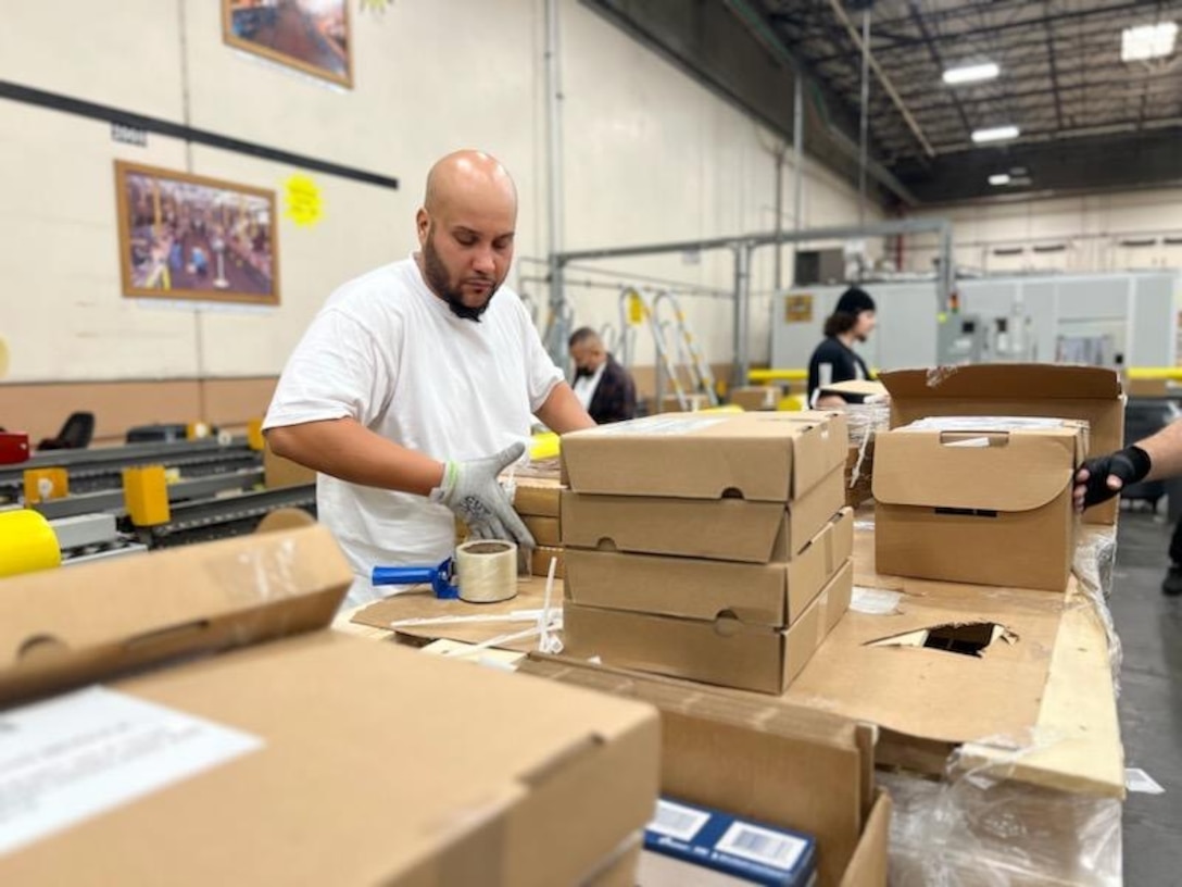 Amritpal Singh packs components into an Express Ration box on May 22, 2023 inside of a distribution warehouse.