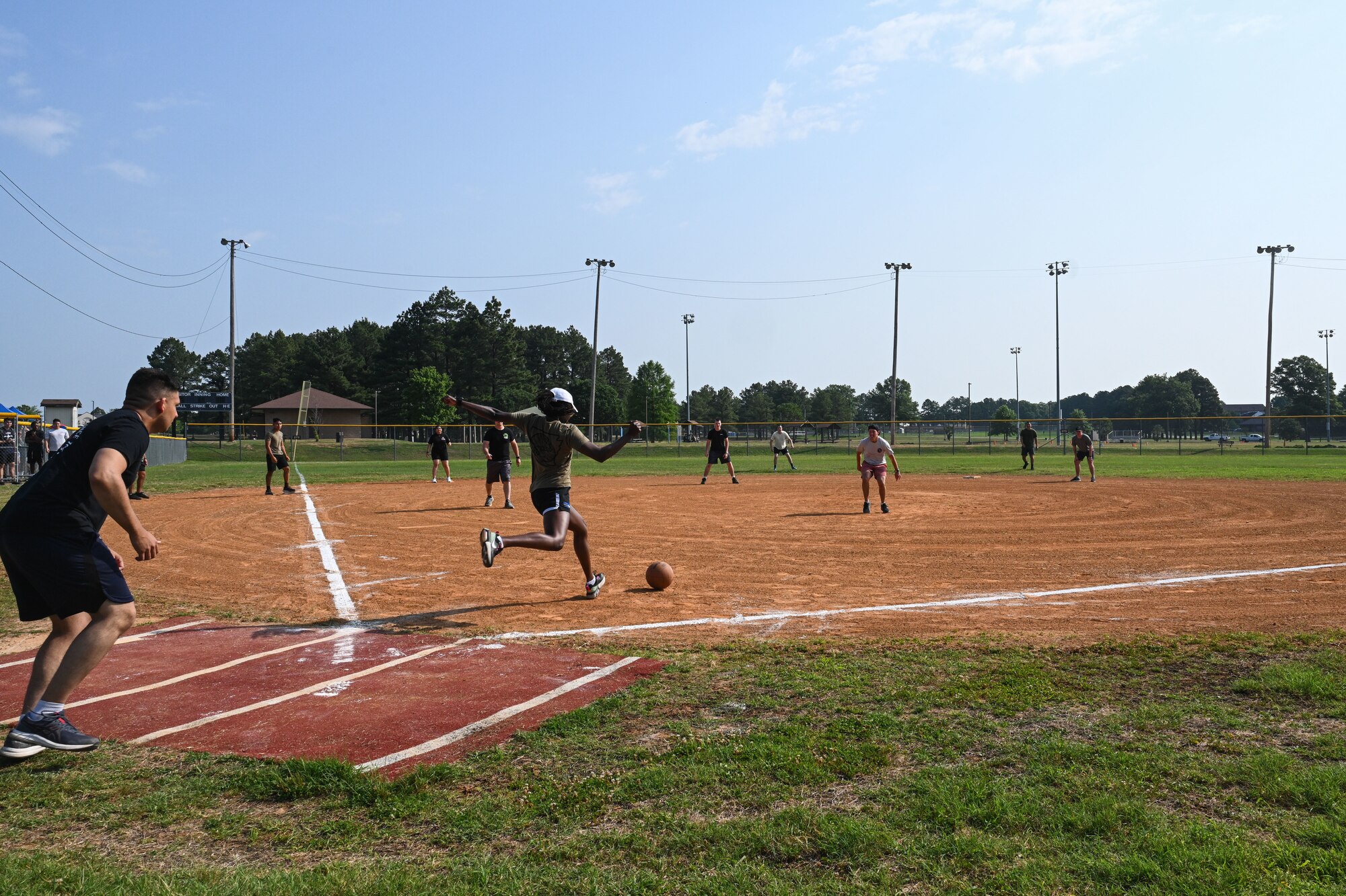Airmen participate in a kickball