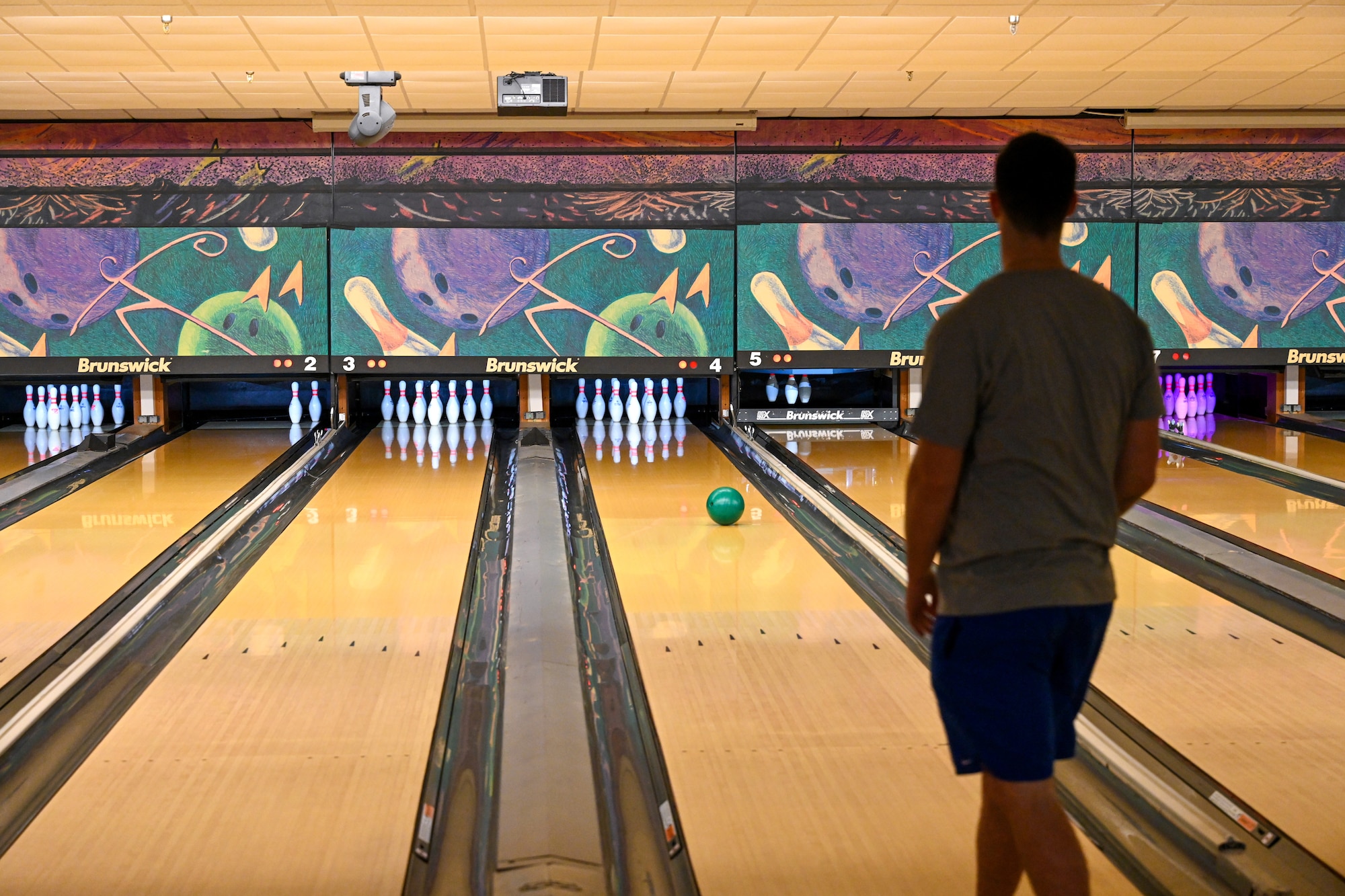 a man rolls a bowling ball