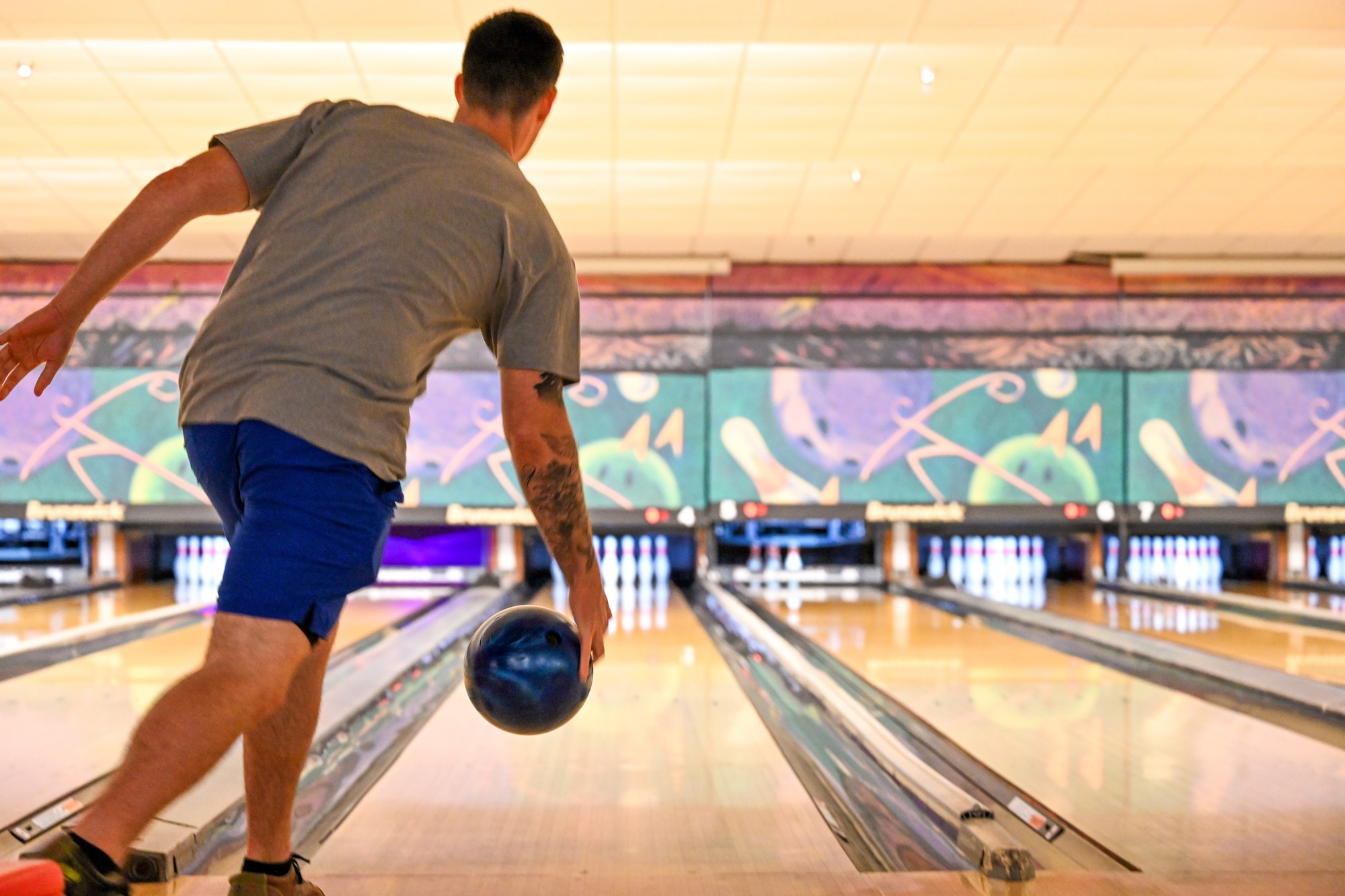 a man rolls a bowling ball