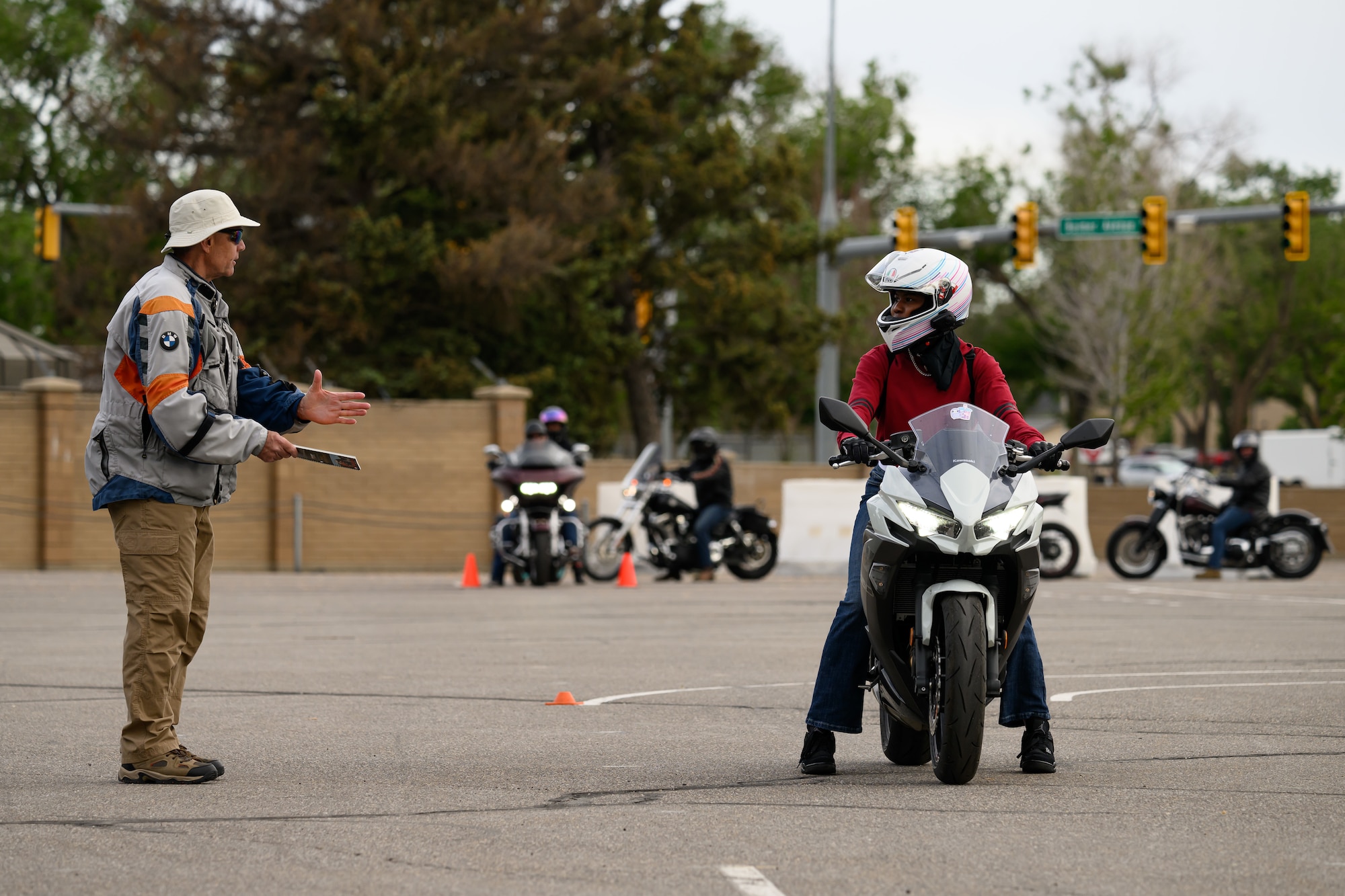 Left, Michael Hensley, rider coach, speaks with Jamia Jones during a Basic Rider Course at Hill Air Force Base, Utah, May 26, 2023. The 75th Air Base Wing safety office maintains a SharePoint that provides motorcyclists with information and resources regarding safety, requirements and training for anyone with base access.  (U.S. Air Force photo by R. Nial Bradshaw)