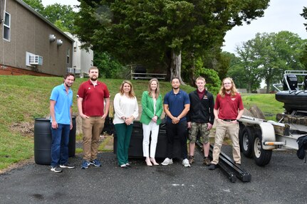 IMAGE: Naval Surface Warfare Center Dahlgren Division’s Chief Technology Officer Jennifer Clift, along with other NSWCDD personnel, stand with Virginia Tech students in front of a barge on May 9.