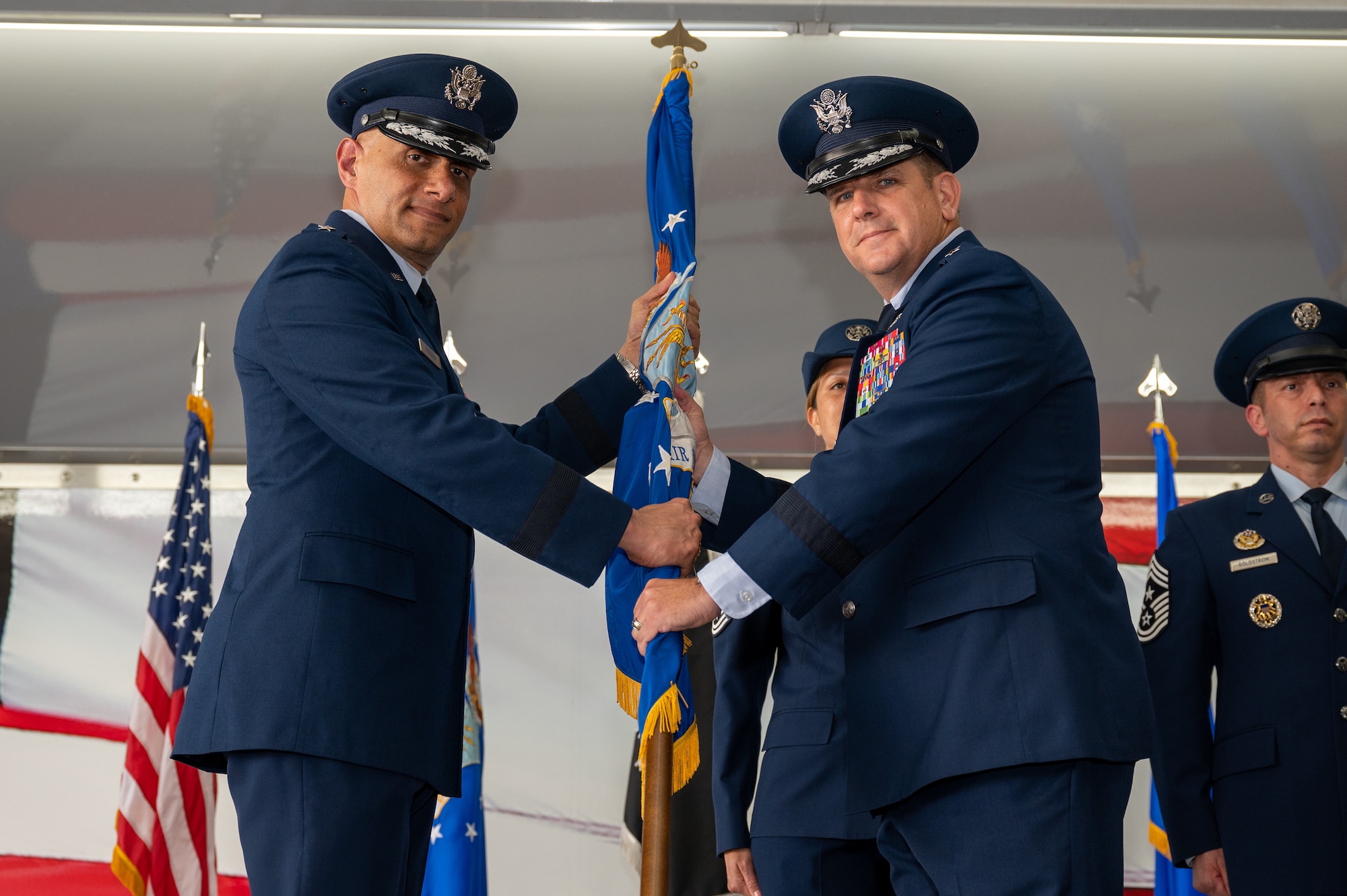 U.S. Air Force Lt. Gen. Brian Robinson, commander of Air Education and Training Command, presents the guidon to Brig. Gen. Christopher Amrhein, incoming commander of Air Force Recruiting Service, during a change of command ceremony