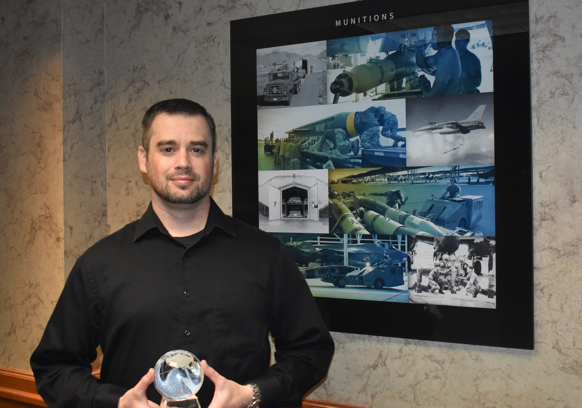 Jonathan Bingham, 75th Air Base Wing History Office historian, was displays the Air Force Materiel Command award for AFMC 2022 Best Wing History Office, which was presented at an awards presentation May 18 at Wright-Patterson AFB, Ohio. (U.S. Air Force photo by Kendahl Johnson)