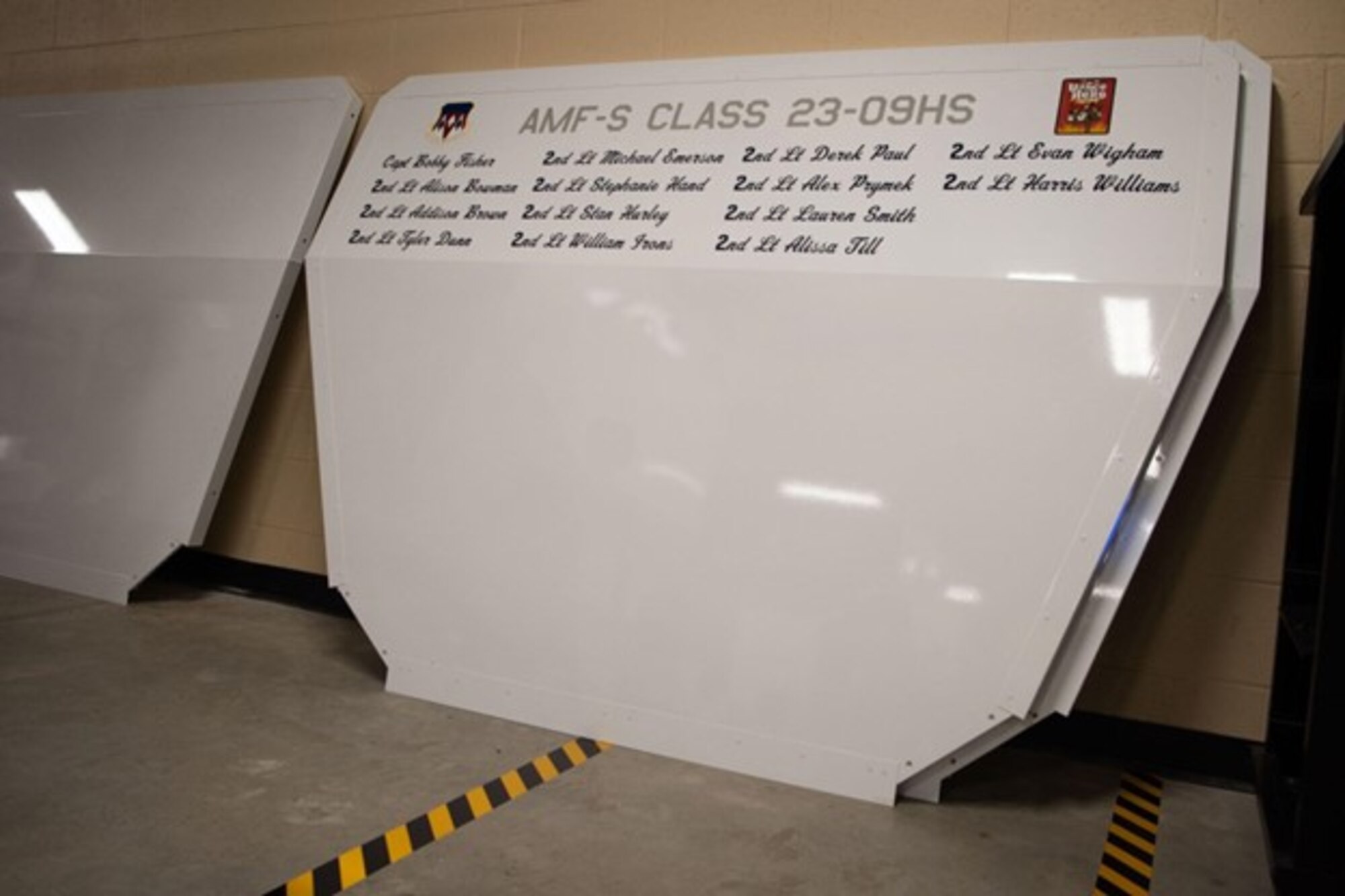 Names of each student on a nose cone of a aircraft from the first AMF-S class at Vance