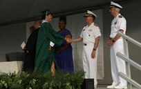 Vice Adm. Thomas E. Ishee, commander of U.S. Sixth Fleet, shakes a graduate’s hand at the Naples Middle/High School graduation ceremony at Carney Park in Pozzuoli, Italy, June 1, 2023.  U.S. Sixth Fleet is permanently assigned to NAVEUR-NAVAF, and employs maritime forces through the full spectrum of joint and naval operations.