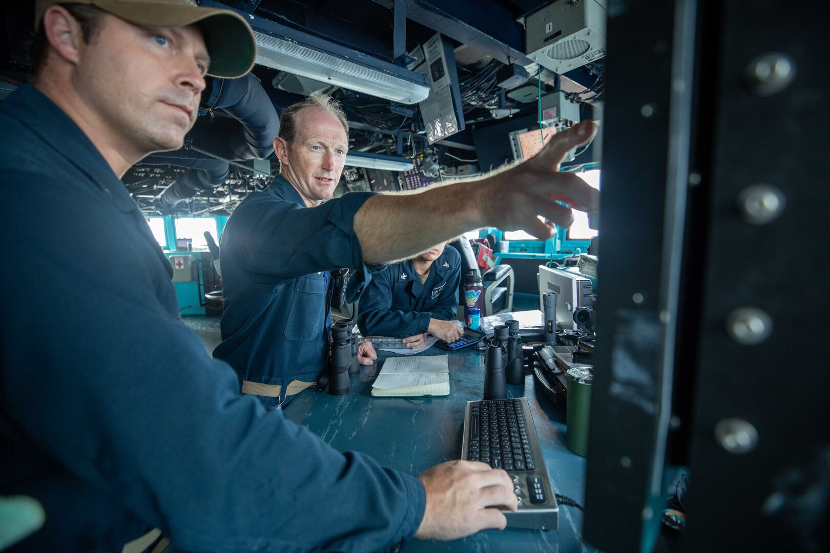 Cmdr. Kevin Schaeffer, commanding officer of the Arleigh Burke-class guided-missile destroyer USS Chung-Hoon (DDG 93) and Lt. William Stimson discuss safe navigation and plotting during a transit through the Taiwan Strait. USS Chung-Hoon is on a routine deployment to U.S. 7th Fleet and is assigned to Commander, Task Force (CTF 71)/ Destroyer Squadron (DESRON) 15. CTF 71/DESRON 15 is the largest forward-deployed DESRON and the U.S. 7th Fleet’s principal surface force.