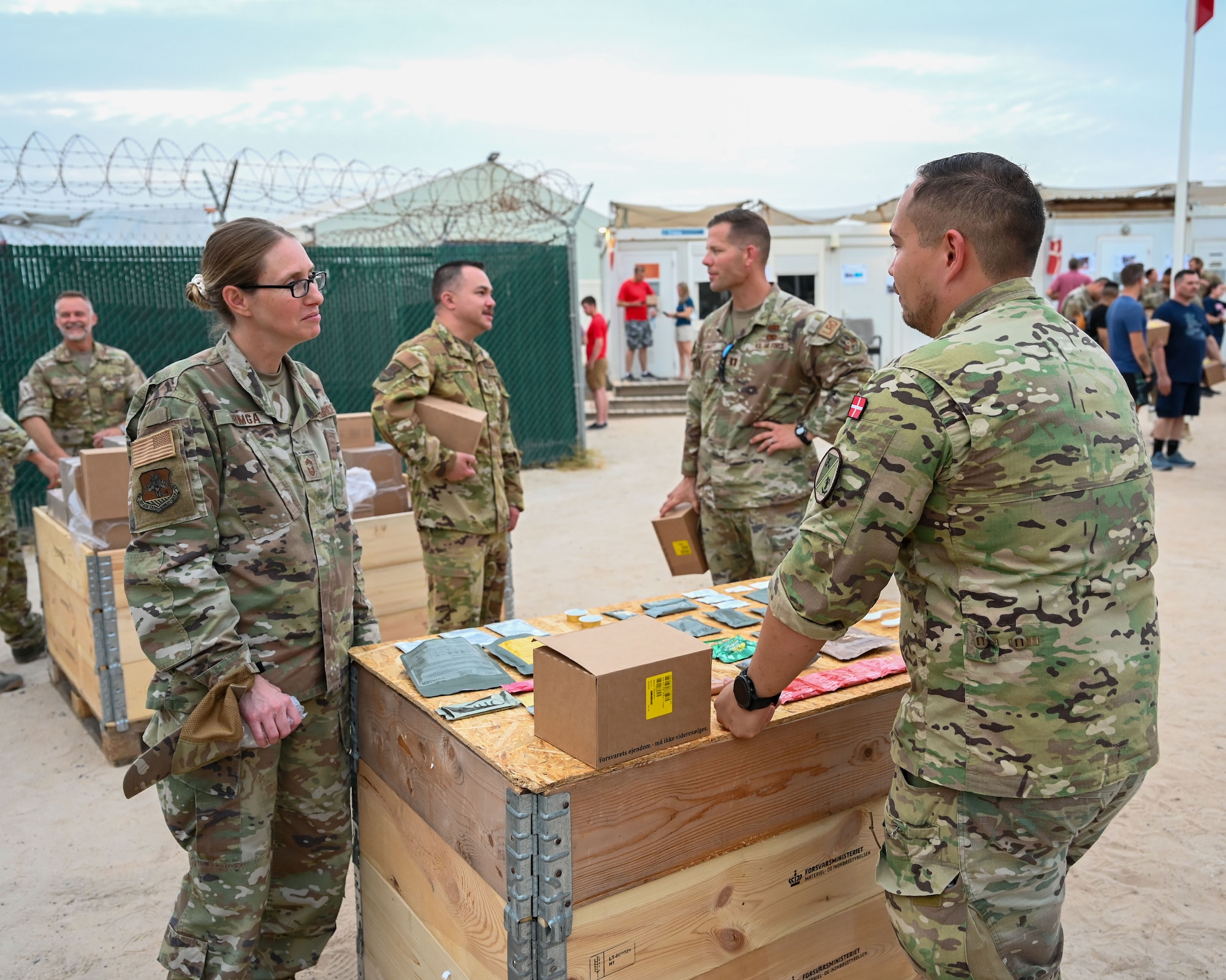 A member of the Royal Danish Air Force speaks with members of the 386th Air Expeditionary Wing during an Open House at Ali Al Salem Air Base, Kuwait, May 30, 2023.