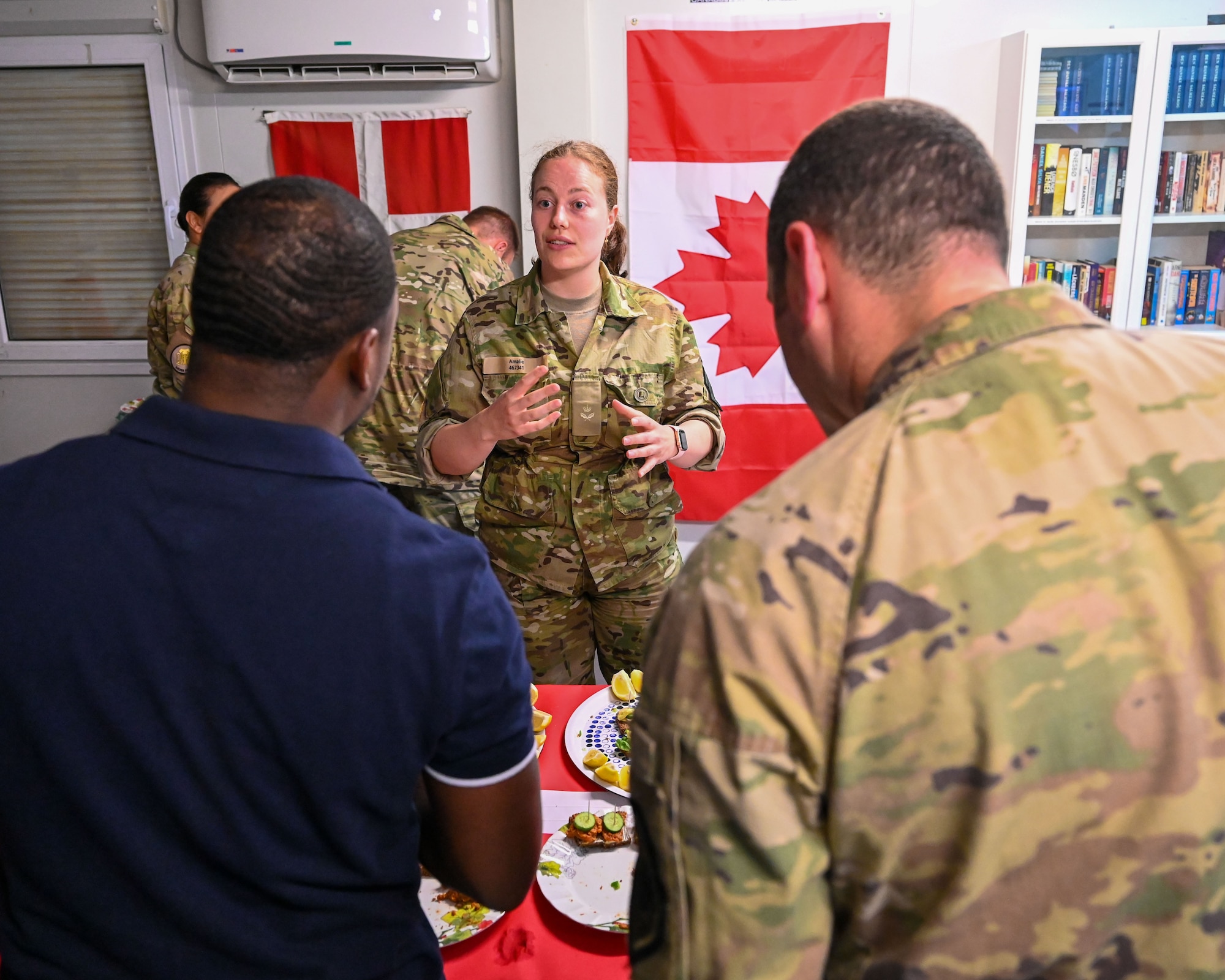 A member of the Royal Danish Air Force speaks with members of the 386th Air Expeditionary Wing during an Open House at Ali Al Salem Air Base, Kuwait, May 30, 2023. The open house reinforced valued partnership between Denmark and U.S. Forces to support stability in the region. (U.S. Air Force photo by Staff Sgt. Breanna Diaz)