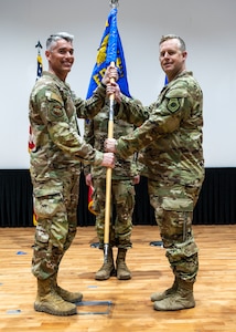 U.S. Air force Airmen furl and sheathe the 407th EOSS guidon, during the squadron re-designation to the 386th EOSS, June 2, 2023, at Ali Al Salem Air Base, Kuwait.
