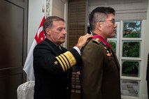SINGAPORE (June 1, 2023) Lt. Gen. Melvyn Ong, former Chief of Defence Force, Singapore Armed Forces, receives the Legion of Merit medal pinned by Adm. John C. Aquilino, Commander U.S. Indo-Pacific Command, in Singapore. Ong received the award for exceptionally meritorious service, where his superior effort, outstanding leadership and personal initiative bolstered and supported mutually beneficial areas of cooperation between the U.S. and Singapore armed forces, including the creation of Singapore’s Digital and Intelligence Service, and the multilateral counterterrorism information facility. (U.S. Navy photo by Chief Mass Communication Specialist Shannon M. Smith)