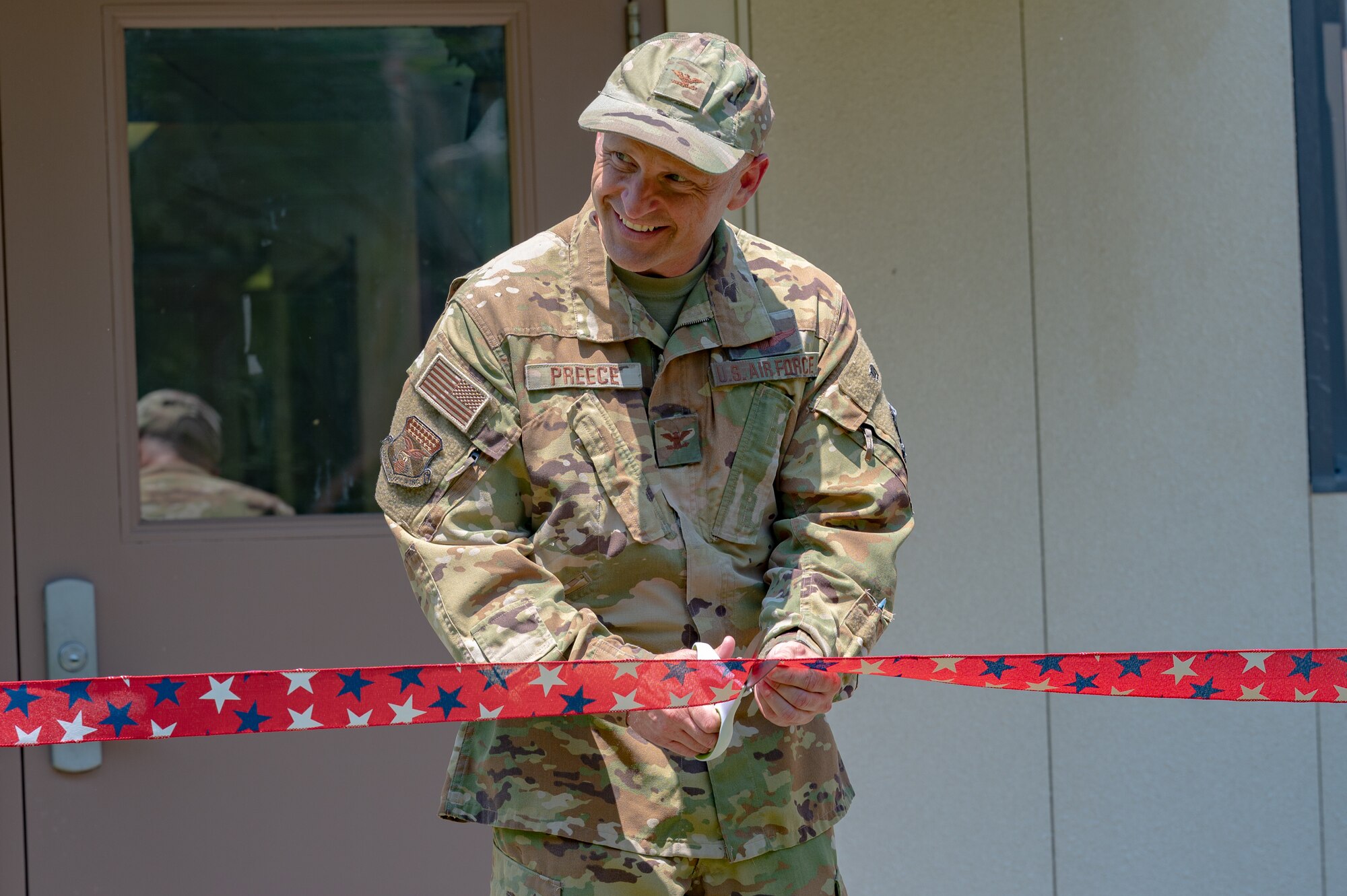 U.S. Air Force Col. Bryan Preece, 130th Airlift Wing Commander, cuts the ribbon to officially open the Airman Readiness Center (ARC) during a ribbon cutting ceremony at McLaughlin Air National Guard Base, Charleston, W.Va., held May 3, 2023. The ARC will house the Director of Psychological Health, the Sexual Assault Response Coordinator, the Wing Chaplain's Office, and the Airman and Family Readiness Program Manager. (U.S. Air National Guard photo by 2nd Lt. De-Juan Haley)