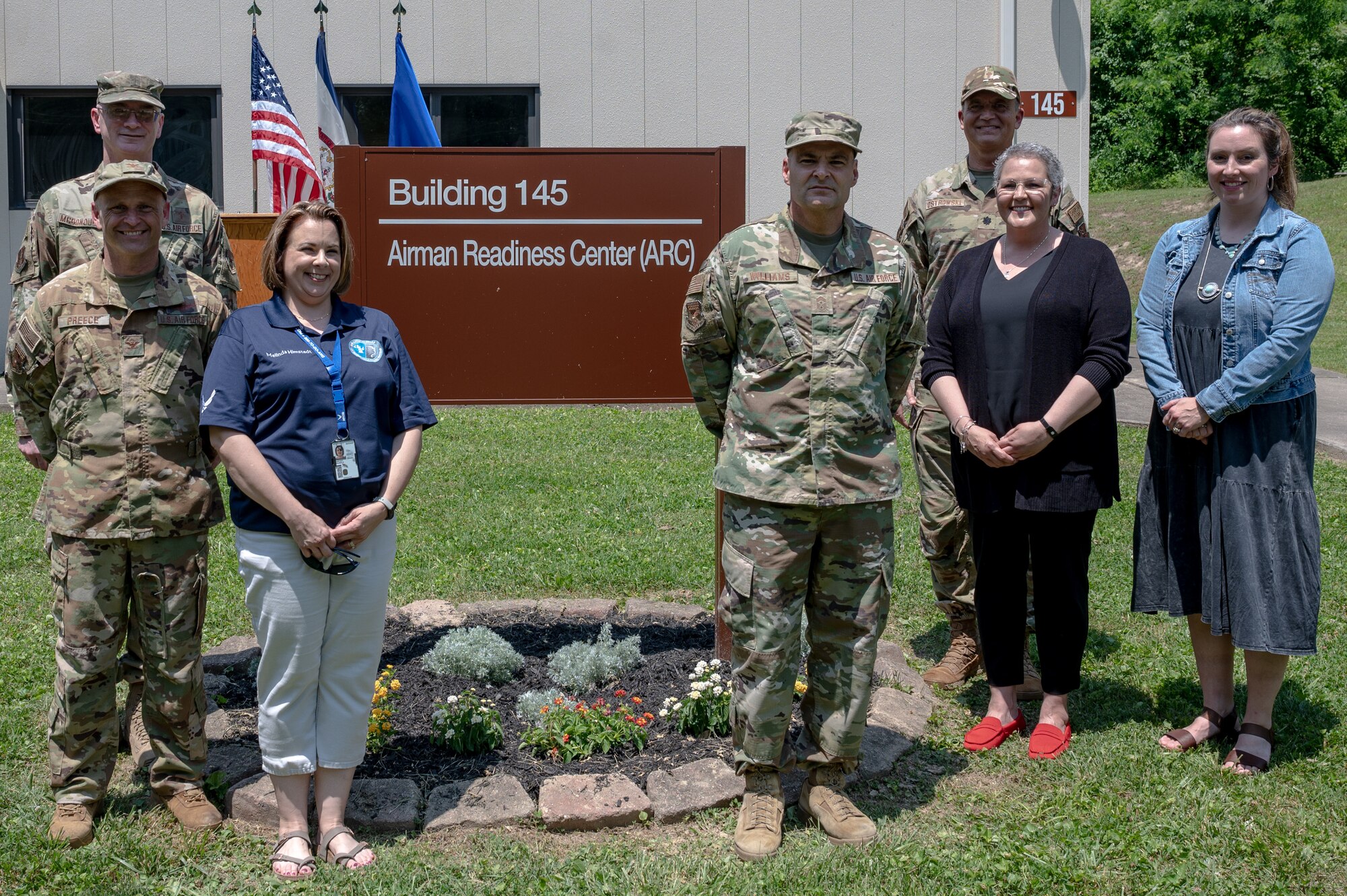 130th Airlift Wing commander Col. Bryan Preece (1st row left) and 130th Airlift Wing Command Chief Kevan Williams (center right) pose for a group photo with the directors of the 130th Airlift Wing helping agencies after the ribbon cutting ceremony to open the Airman Readiness Center (ARC) at McLaughlin Air National Guard Base, Charleston, W.Va. held May 3, 2023. The ARC will house the Director of Psychological Health, the Sexual Assault Response Coordinator, the Wing Chaplain's Office, and the Airman and Family Readiness Program Manager. (U.S. Air National Guard photo by 2nd Lt. De-Juan Haley)