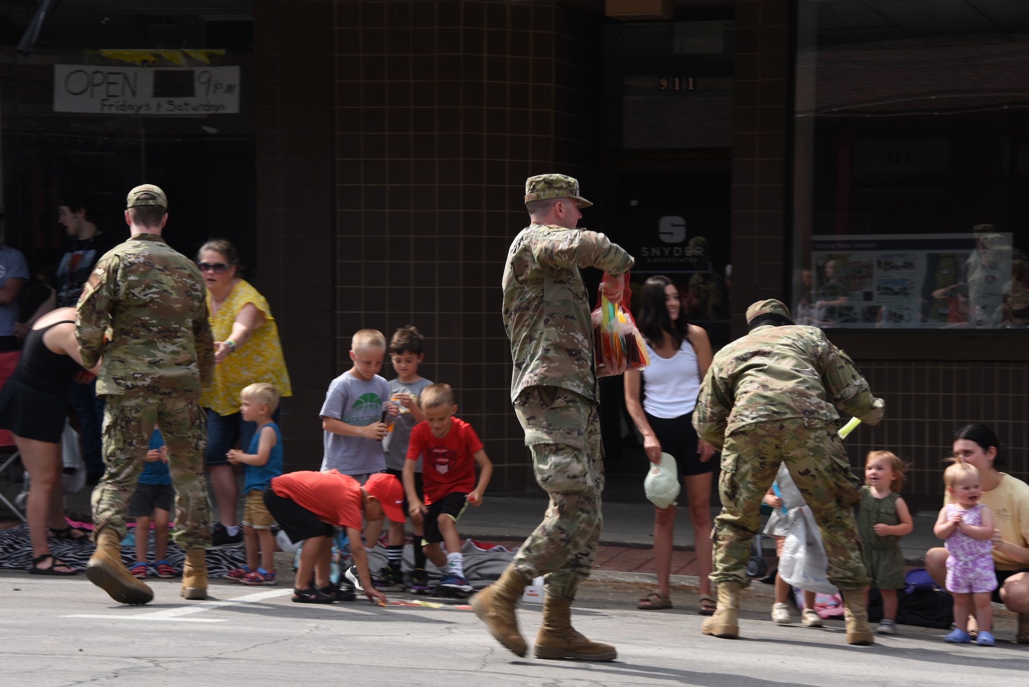 Airmen hand treats to parade goers