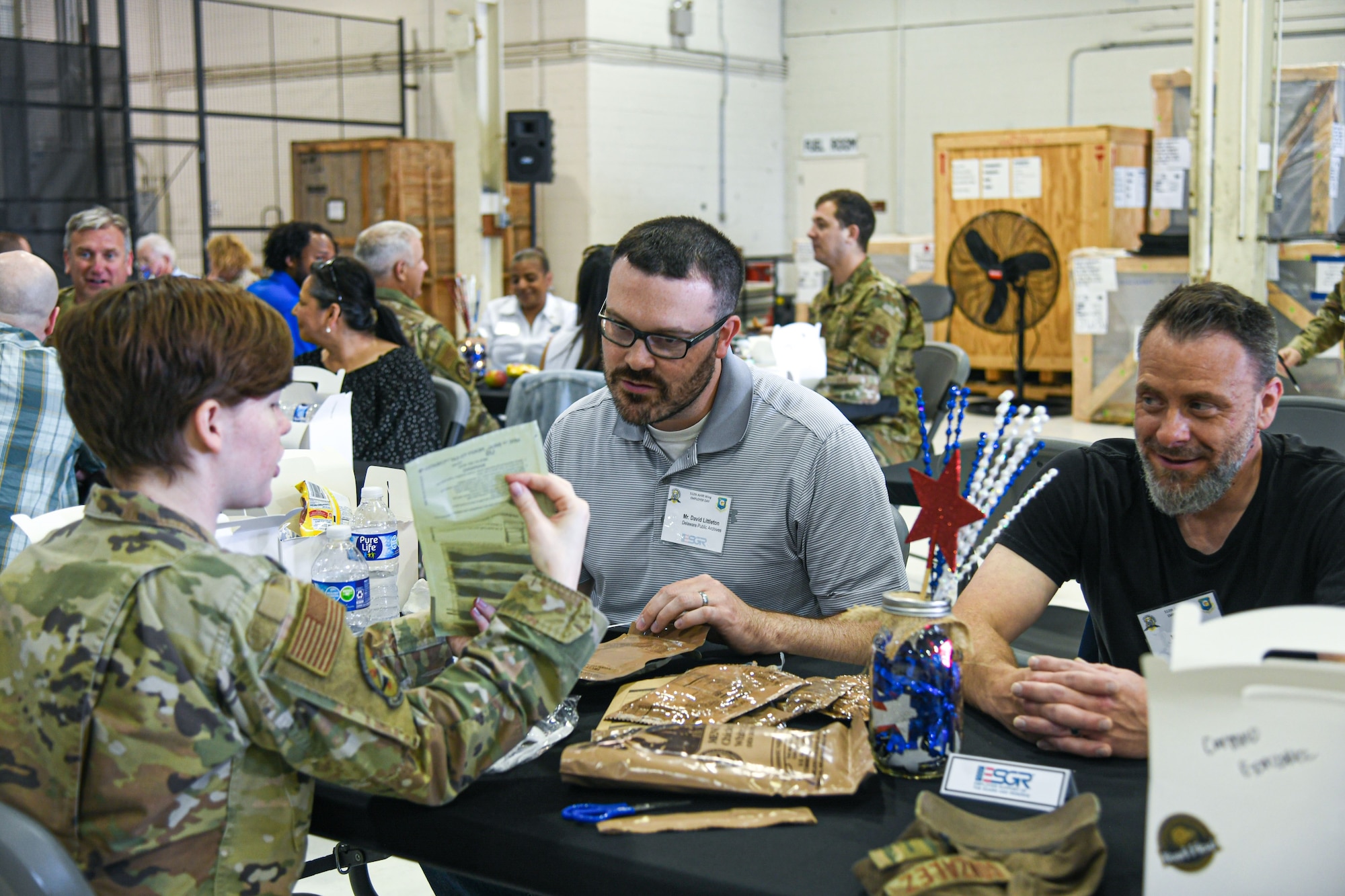 Senior Airman Kelly Kinsley, a 512th Airlift Wing reservist, displays a Meal, Ready-to-Eat heating element during Employer Day on Dover Air Force Base, Delaware, June 3, 2023. Service members eat MRE’s when other food is unavailable in combat or field conditions. (U.S. Air Force photo by Senior Airman Shayna Hodge)