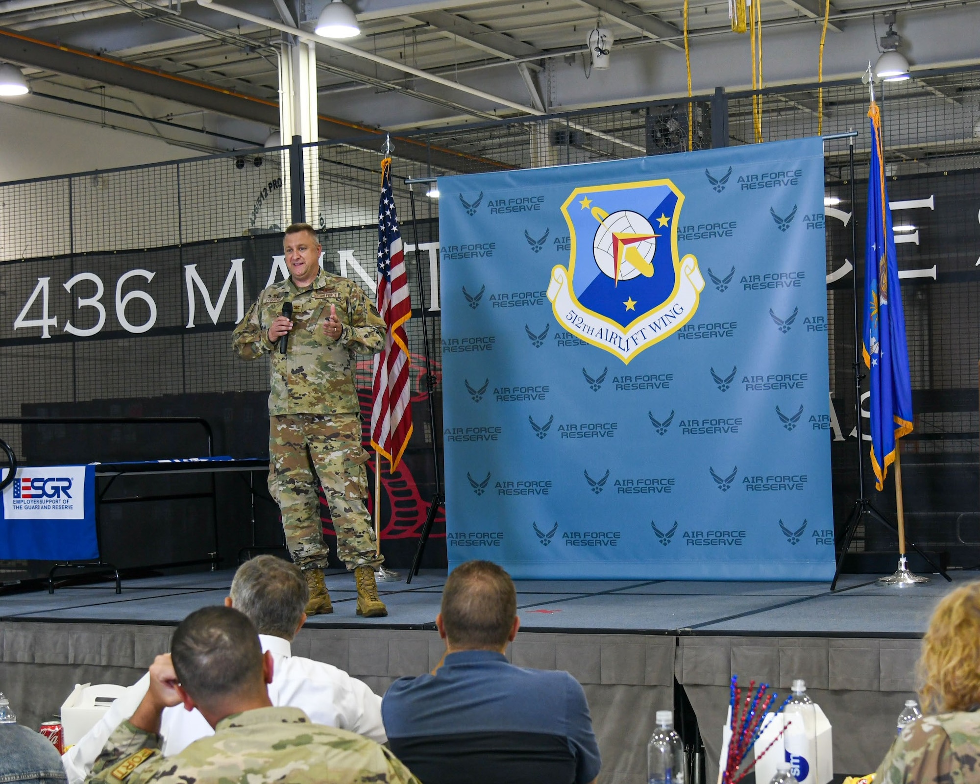 Col. Douglas Stouffer, 512th Airlift Wing commander, speaks to wing members and their employers at a luncheon during Employer Day on Dover Air Force Base, Delaware, June 3, 2023. Stouffer gave a brief history of the base and described the overall mission of the wing. (U.S. Air Force photo by Senior Airman Shayna Hodge)