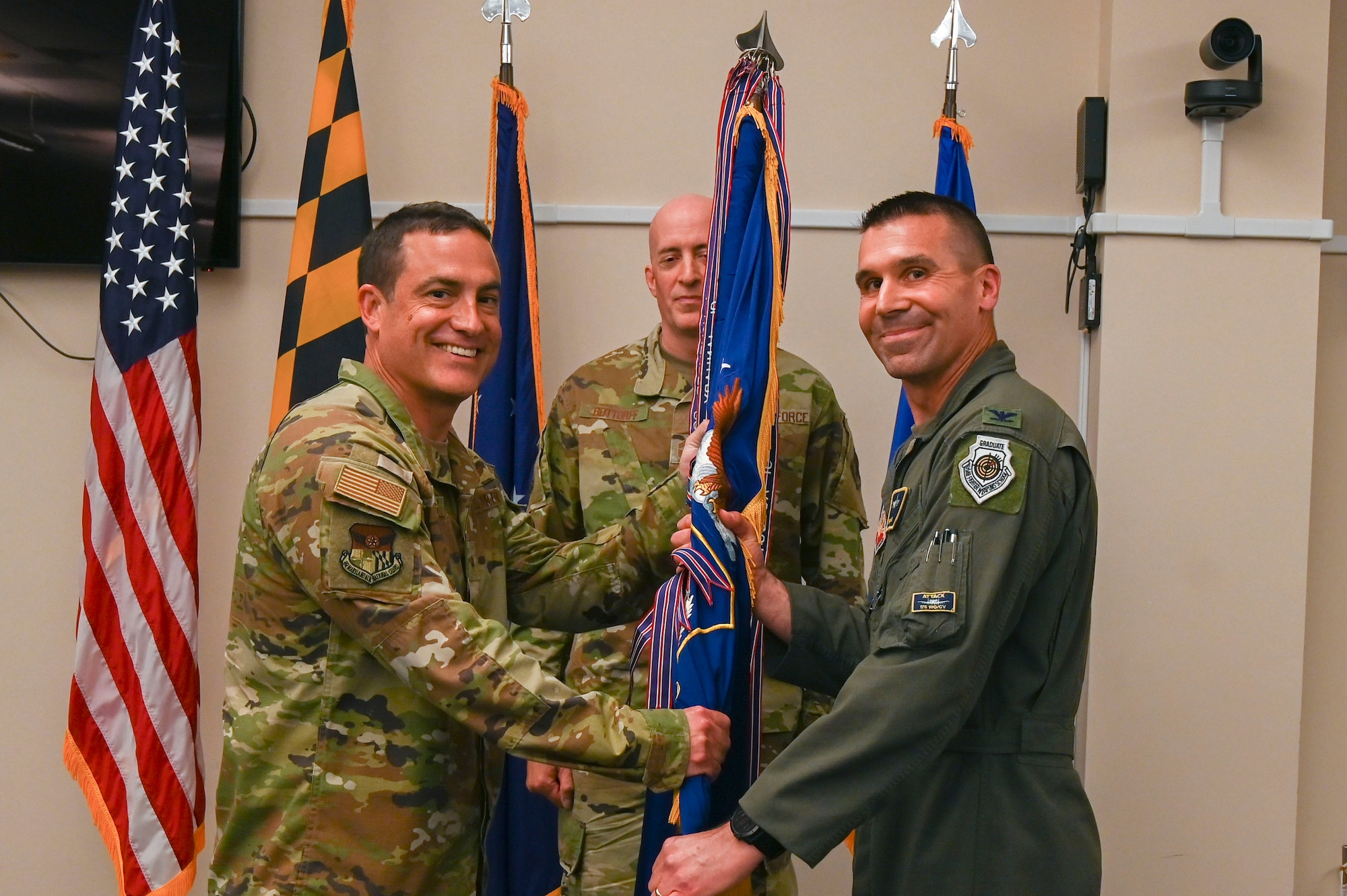 U.S. Air National Guard Brig. Gen. Drew Dougherty, Maryland National Guard assistant adjutant general - Air, passes the guidon to U.S. Air National Guard Col. Richard D. Hunt, incoming 175th Wing commander, during a change of command ceremony at Martin State Air National Guard Base, Middle River, Maryland, June 4, 2023.