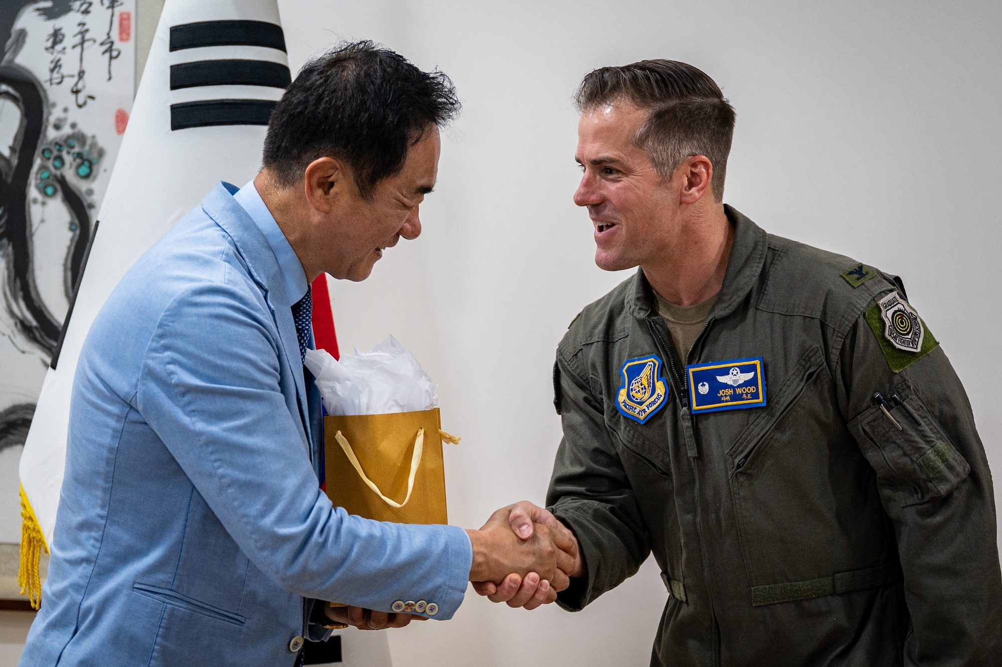 U.S. Air Force Col. Joshua Wood, right, 51st Fighter Wing Commander, presents Mr. Jung, Jang Seon, left, Pyeongtaek City mayor, with a gift at Pyeongtaek City Hall, Republic of Korea, June 1, 2023. During a ceremony held at City Hall, Pyeongtaek City bestowed honorary citizenship upon Wood and his wife. (U.S. Air Force photo by Senior Airman Thomas Sjoberg)