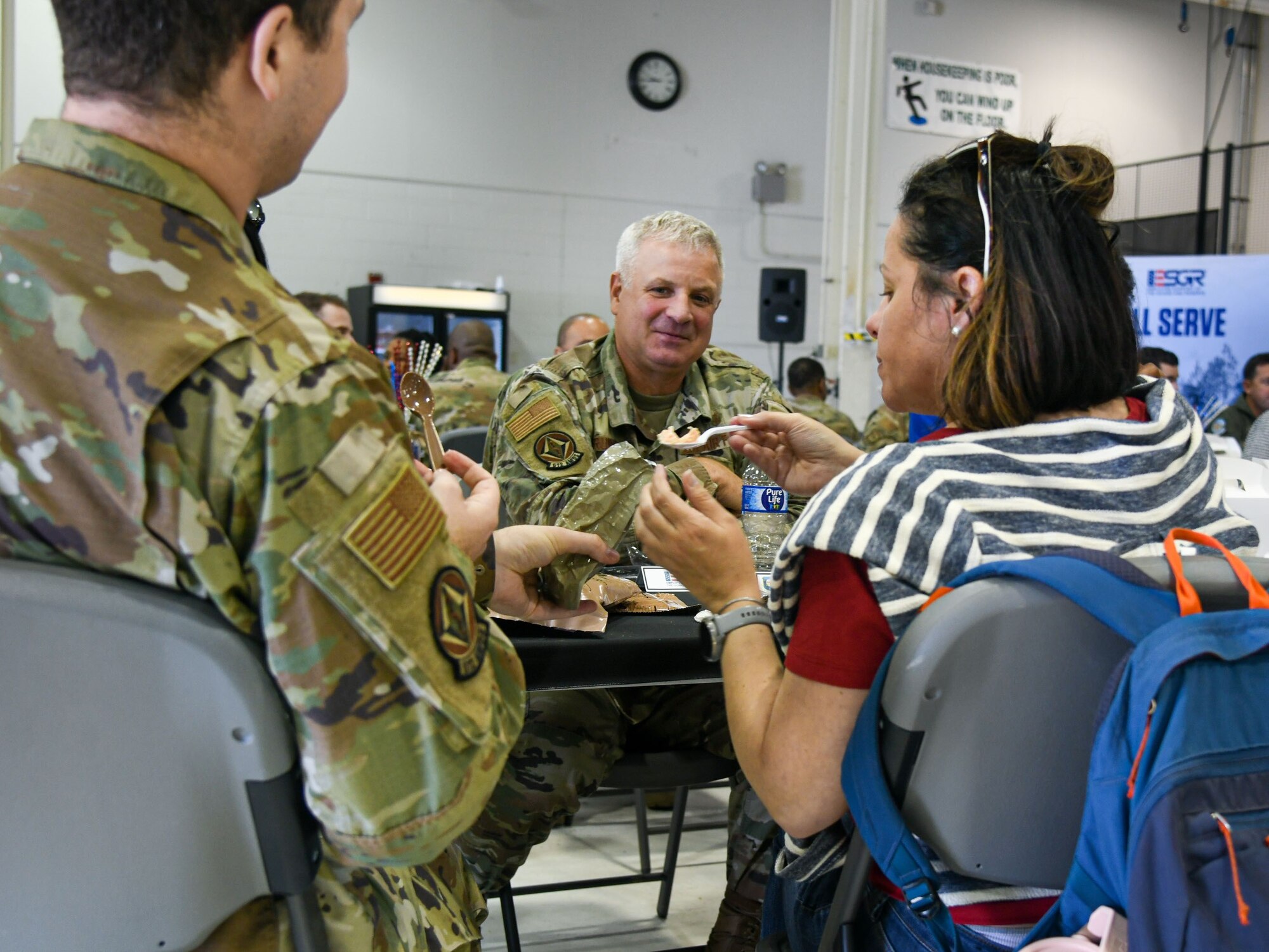 Patricia Isherwood takes out contents from a Meal, Ready-to-Eat, during Employer Day on Dover Air Force Base, Delaware, June 3, 2023. MRE’s were distributed to employers to taste, and to provide insight on what military members eat while in combat or field conditions. (U.S. Air Force photo by Senior Airman Shayna Hodge)