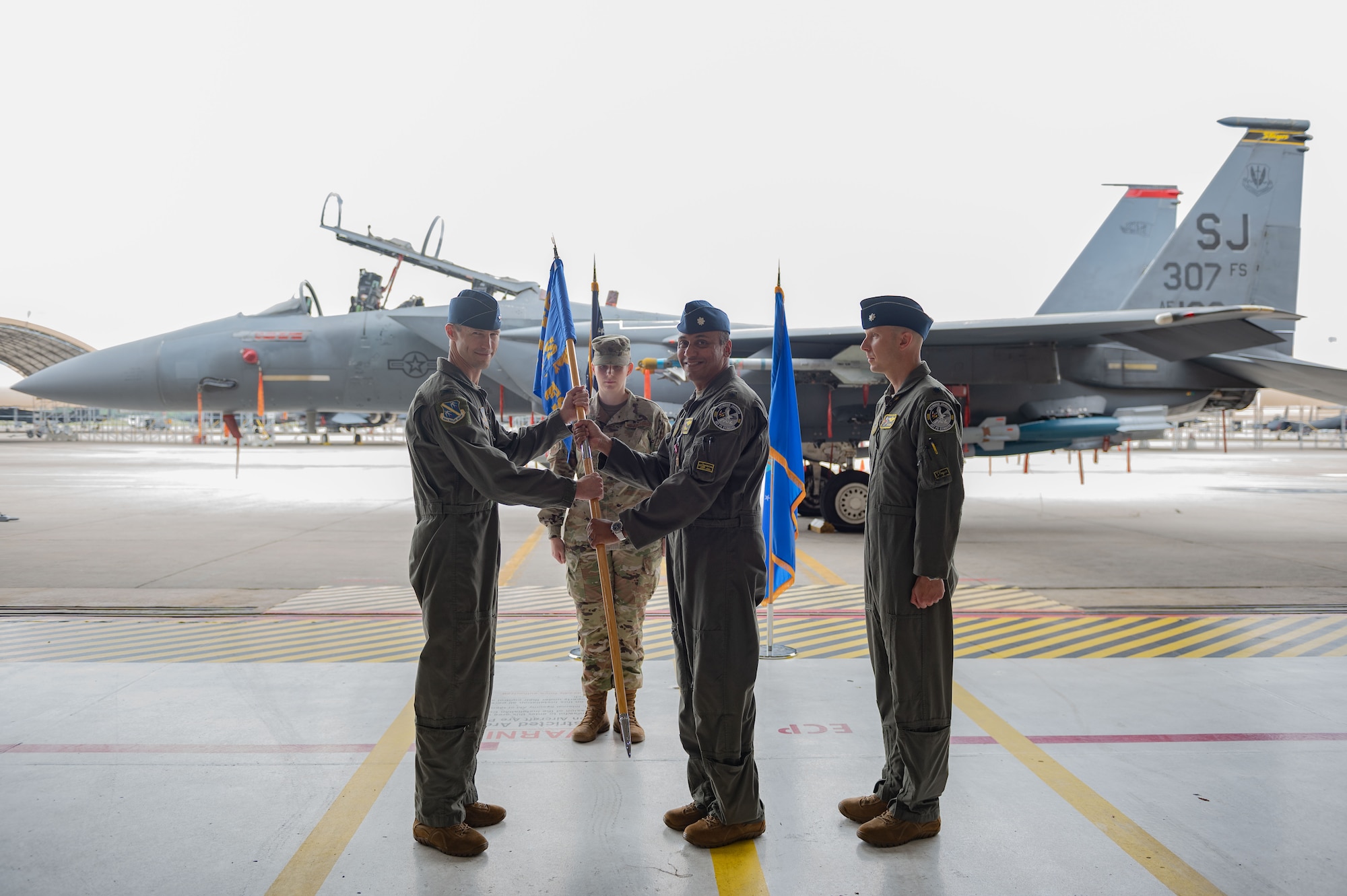 U.S. Air Force Lt. Col. Sriram Krishnam, 307th Fighter Squadron commander, passes the squadron guidon to Col. Chad Shenk, 414th Fighter Squadron commander, during a change of command ceremony at Seymour Johnson Air Force Base, North Carolina, June 2, 2023. Base and community leadership, along with friends and family of the squadron’s incoming and outgoing commanders, gathered to witness the traditional passing of the guidon. (U.S. Air Force photo by Airman 1st Class Rebecca Sirimarco-Lang)
