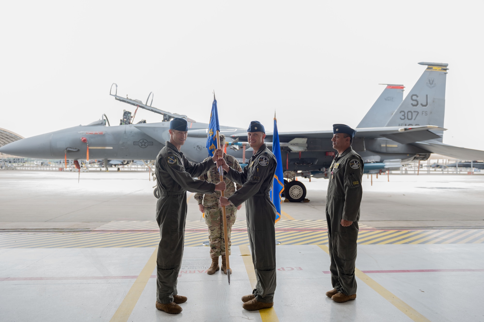 U.S. Air Force Lt Col. Andrew Blaser, incoming 307th commander, accepts the guidon of the 307th FS from Col. Chad Shenk, 414th Fighter Squadron commander, during a change of command ceremony at Seymour Johnson Air Force Base, North Carolina, June 2, 2023. The 307th Fighter Squadron began on 30 January 1942 it became the first operational Army Air Force Fighter Group in the European Theater. (U.S. Air Force photo by Airman 1st Class Rebecca Sirimarco-Lang)