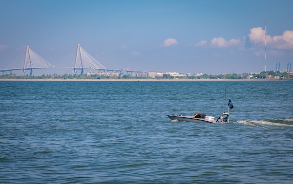 Unmanned surface vessel in water.  Behind in the distance is the Arthur Ravenel Bridge