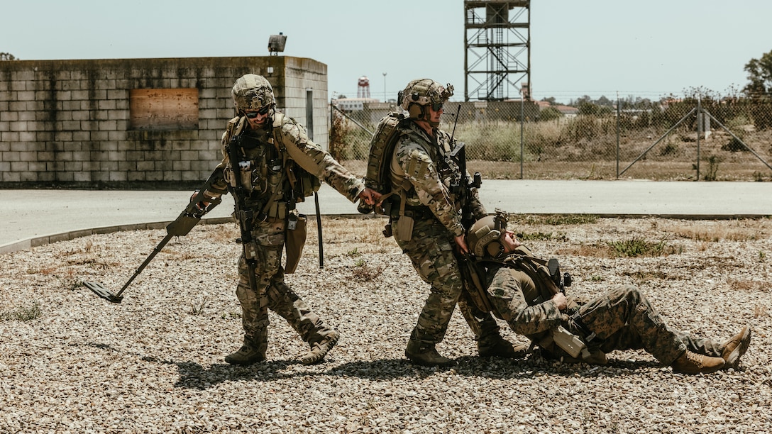 U.S. Marines with Task Force 61/2.5 and Sailors with Explosive Ordnance Disposal Mobile Unit 8, evacuate a casualty during a simulated mine strike in Rota, Spain on May 25, 2023. Task Force 61/2.5 provides naval and joint force commanders with dedicated multi-domain reconnaissance and counter reconnaissance capabilities.